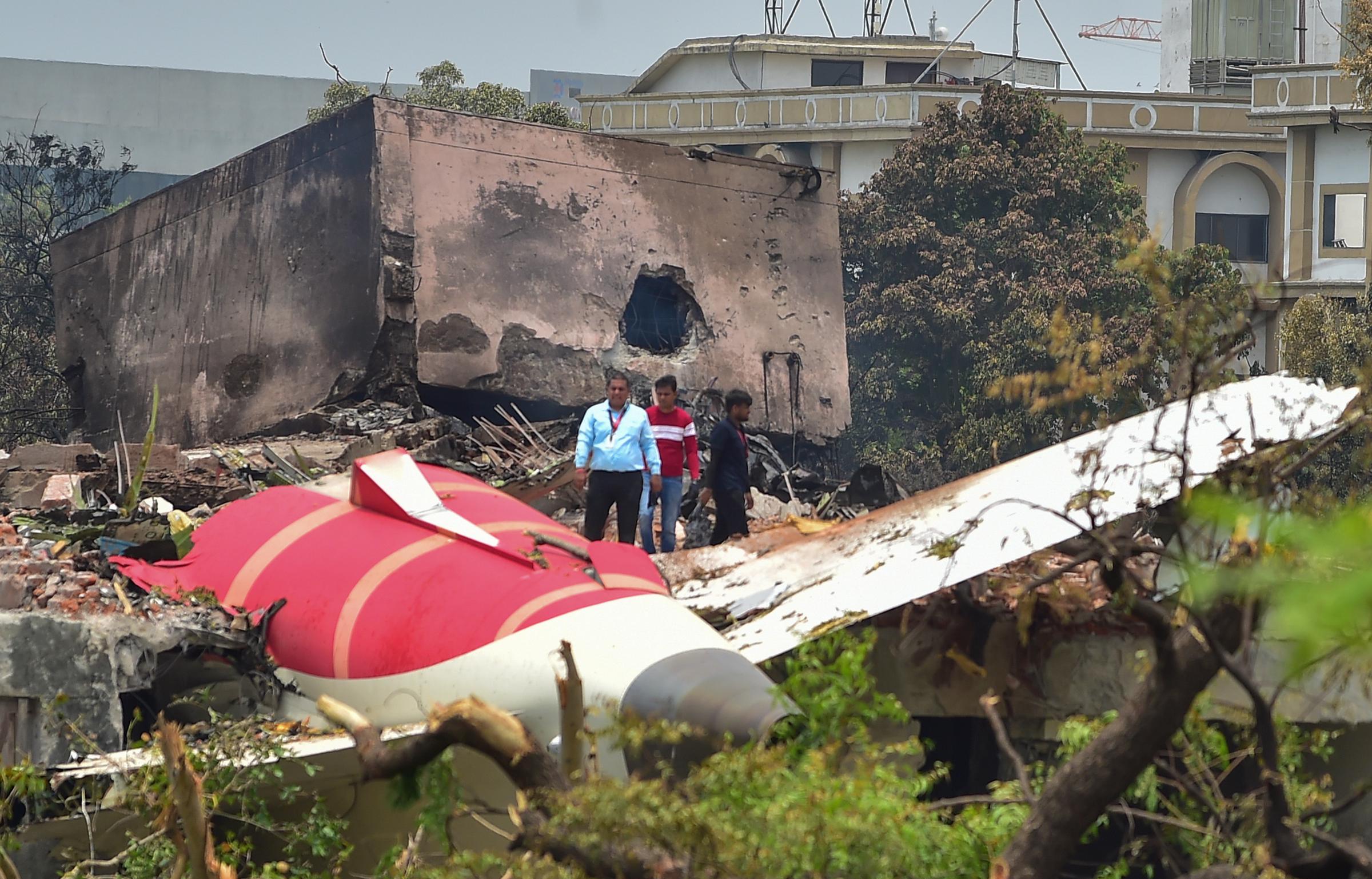 Investigative officials stand at the site of Air India Boeing 787 which crashed in Ahmedabad, India, on June 13, 2025 | Source: Getty Images
