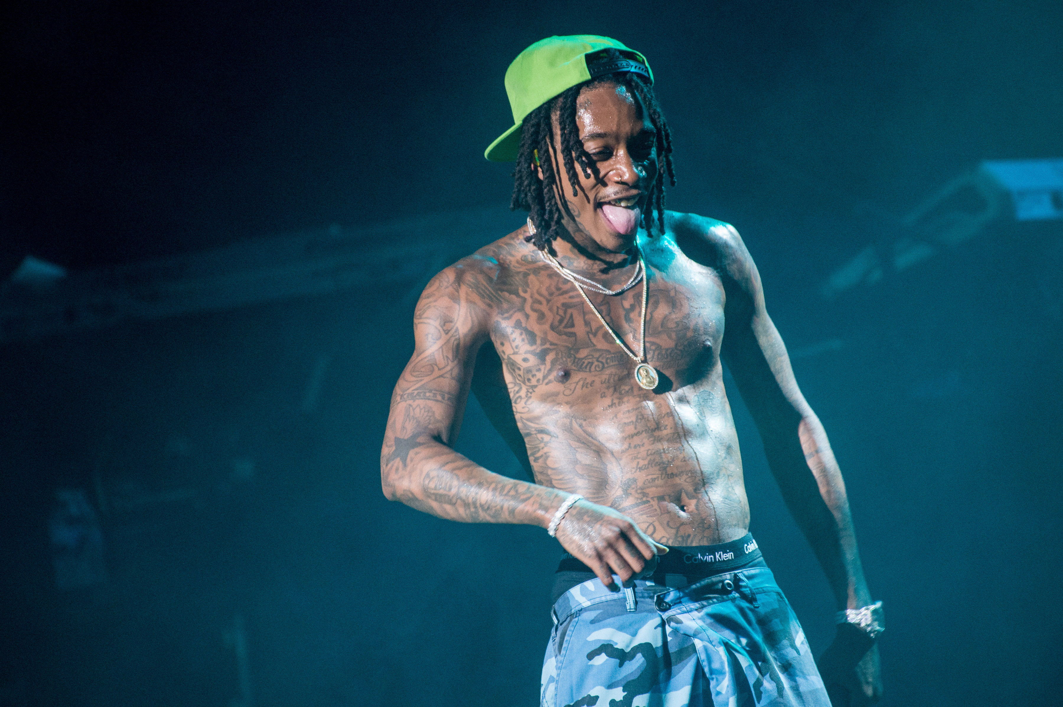 Wiz Khalifa's hard-earned muscle gains were evident as he performed at the Ford Amphitheater at Coney Island Boardwalk in Brooklyn, New York, on August 2, 2018. Taking the stage shirtless, the rapper displayed a noticeably fuller, more athletic physique, reflecting the results of years spent training in mixed martial arts.