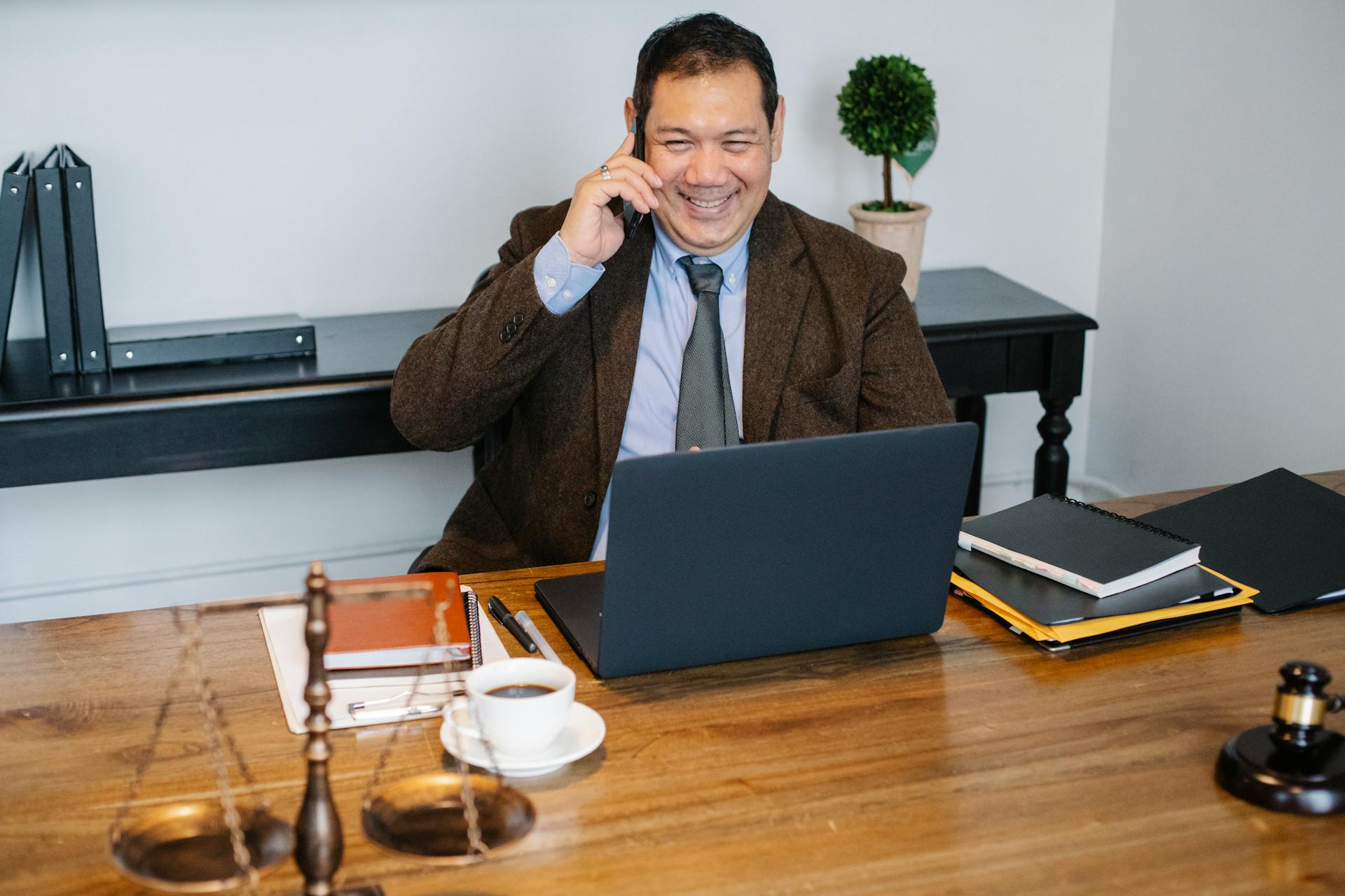 A lawyer talking on the phone in his office | Source: Pexels