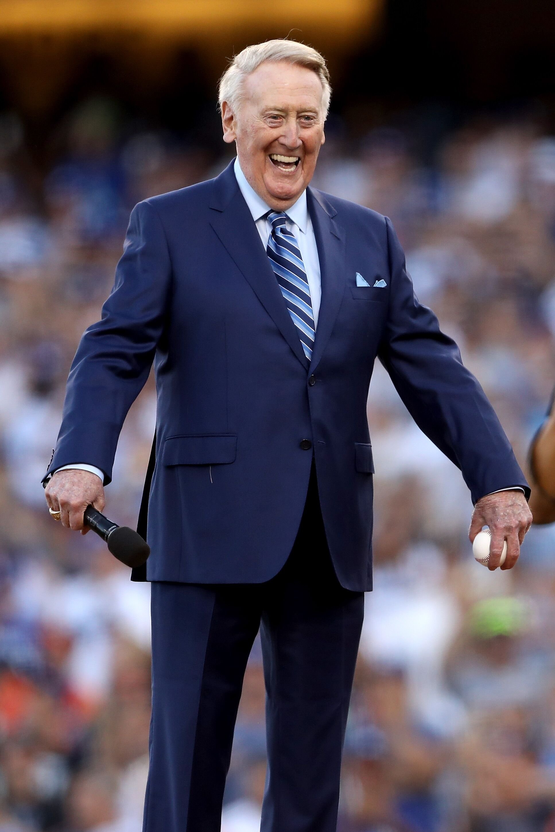 Vin Scully stands on the field before game two of the 2017 World Series between the Houston Astros and the Los Angeles Dodgers at Dodger Stadium on October 25, 2017 in Los Angeles, California | Photo: Getty Images 