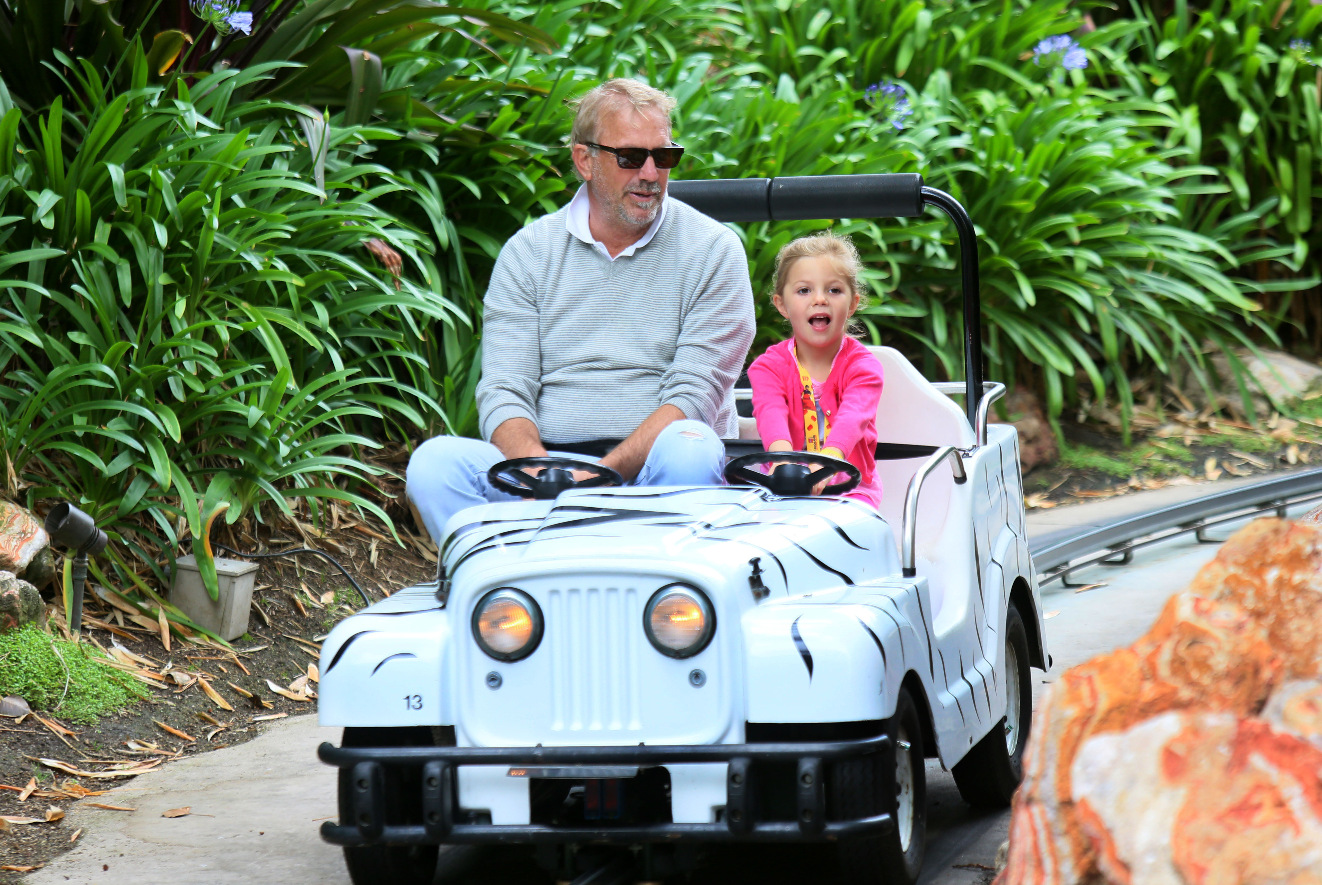 Kevin Costner on a ride with his daughter Grace at Legoland California on Wednesday, May 27, 2015 in Carlsbad, California | Source: Getty Images