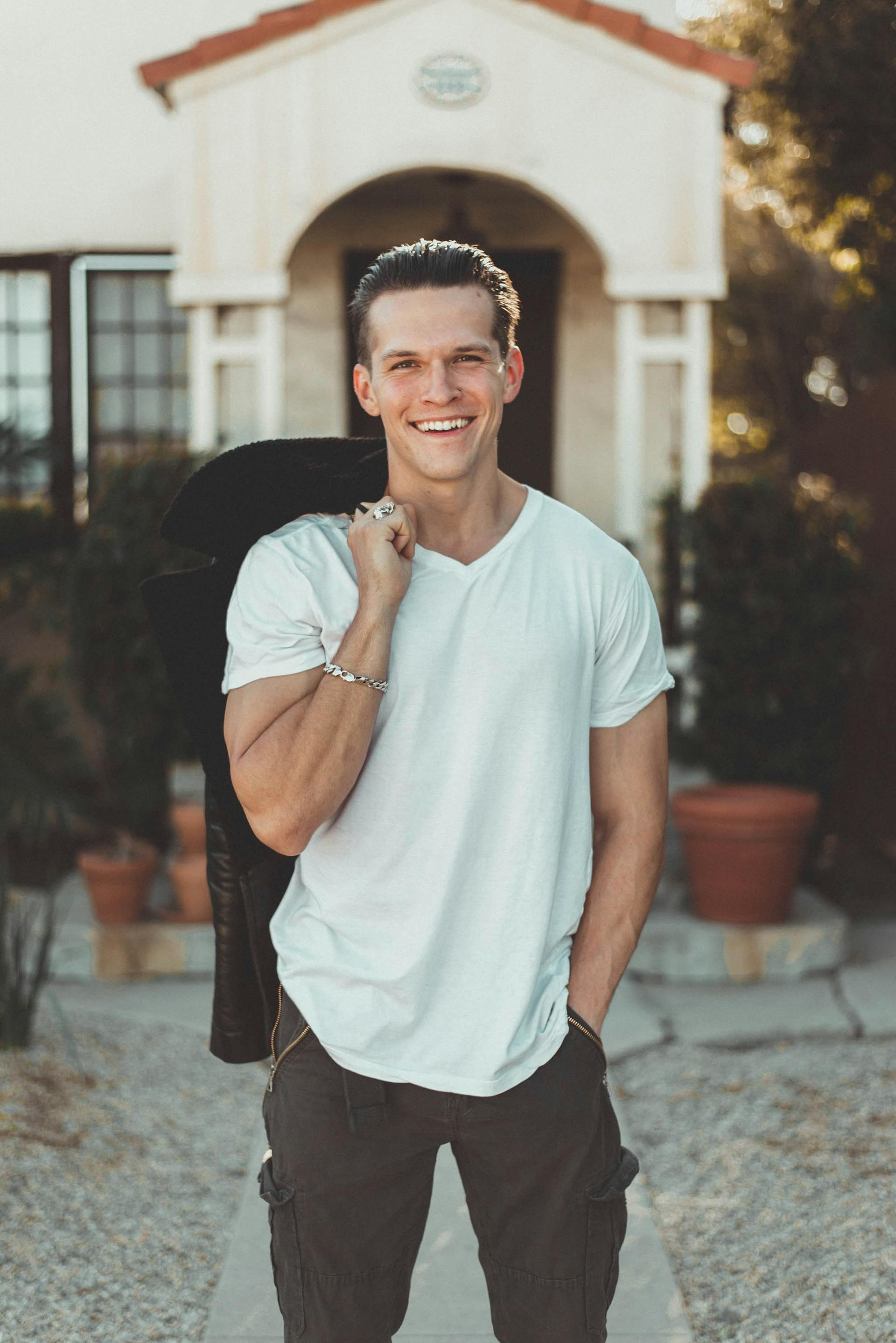 A happy man standing outside a house | Source: Pexels