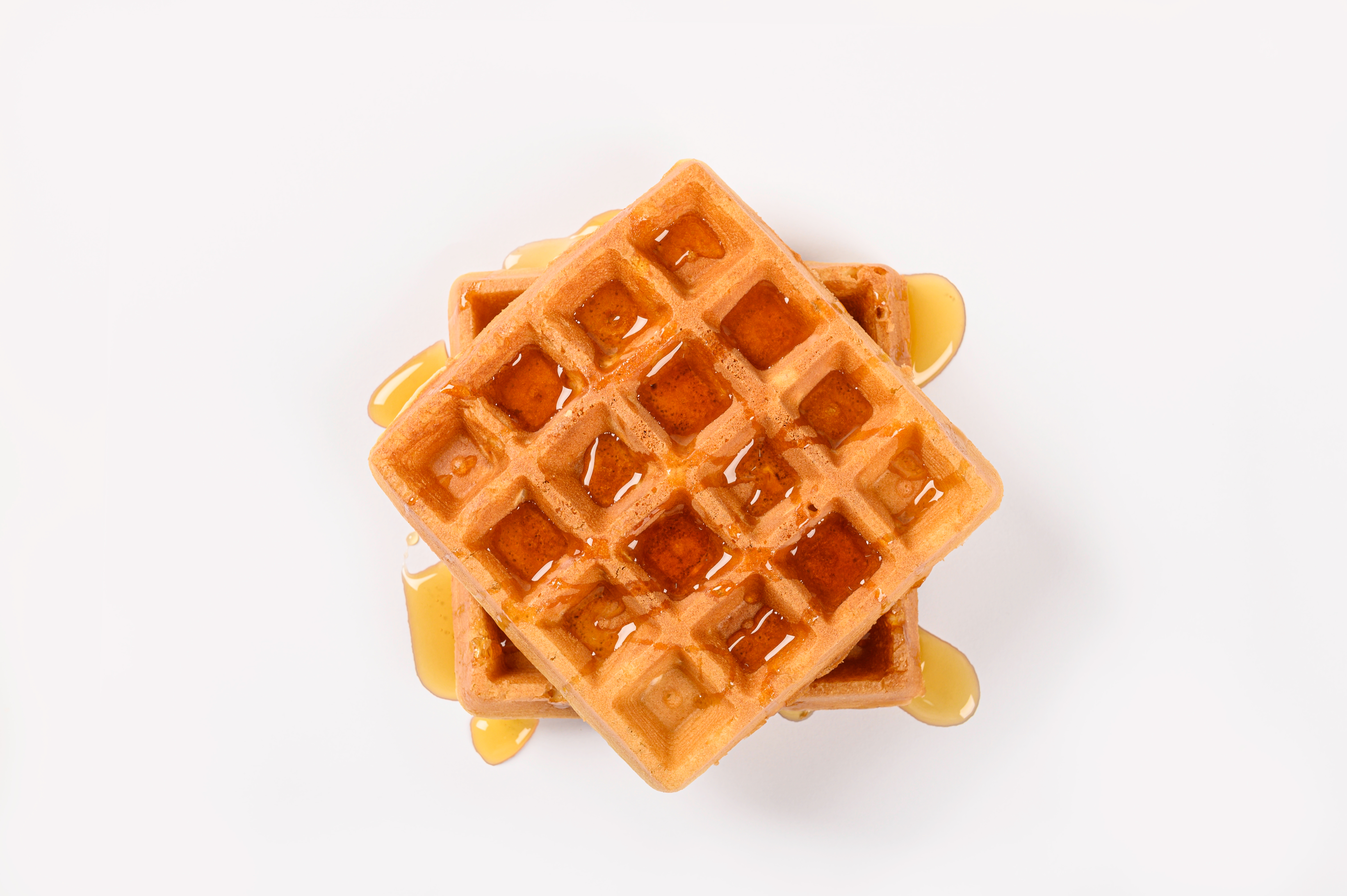 A pile of waffles with syrup on them | Source: Shutterstock