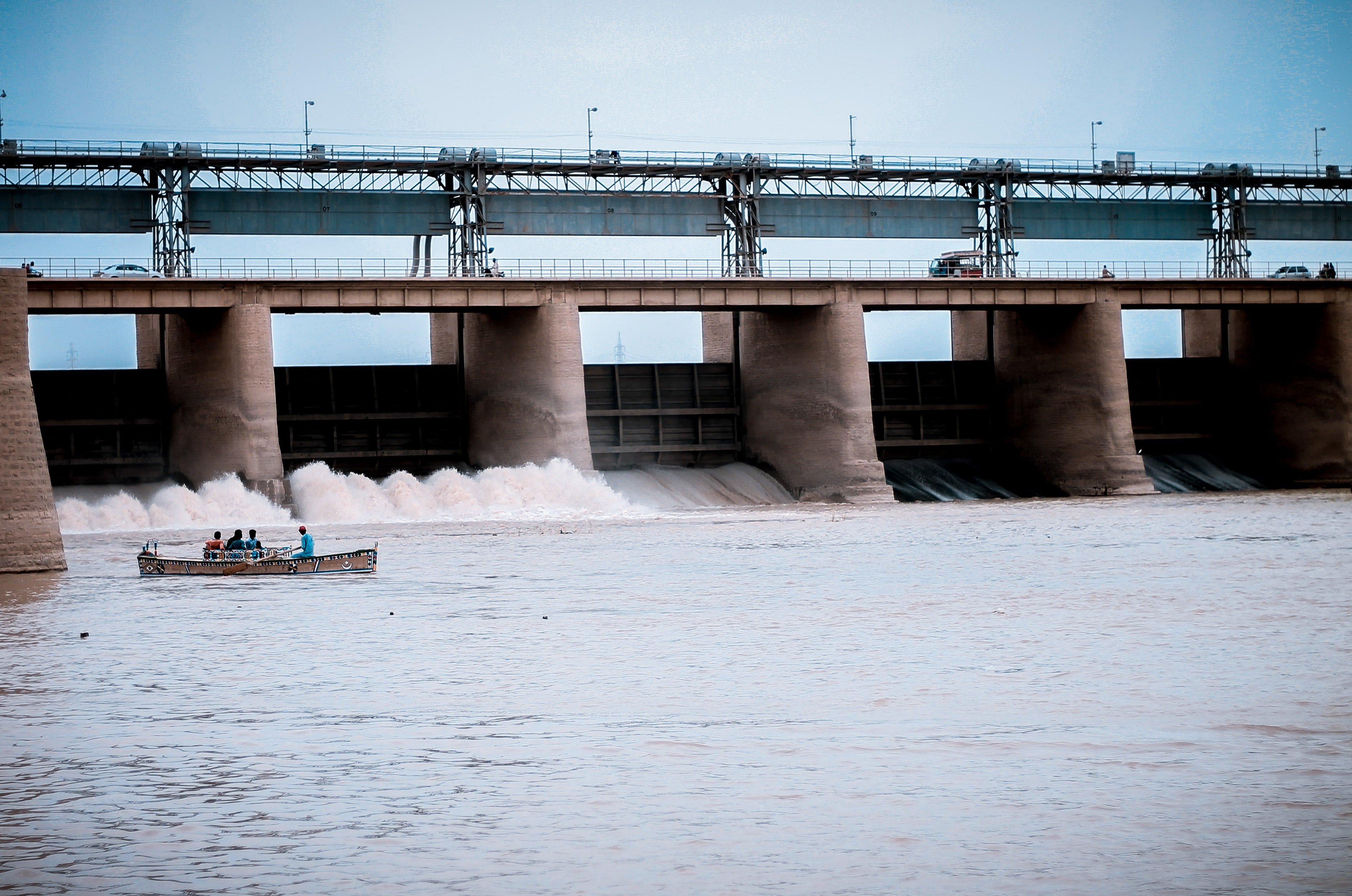 Pictured: A photo of people on a boat near a water dam | Source: Pexels 