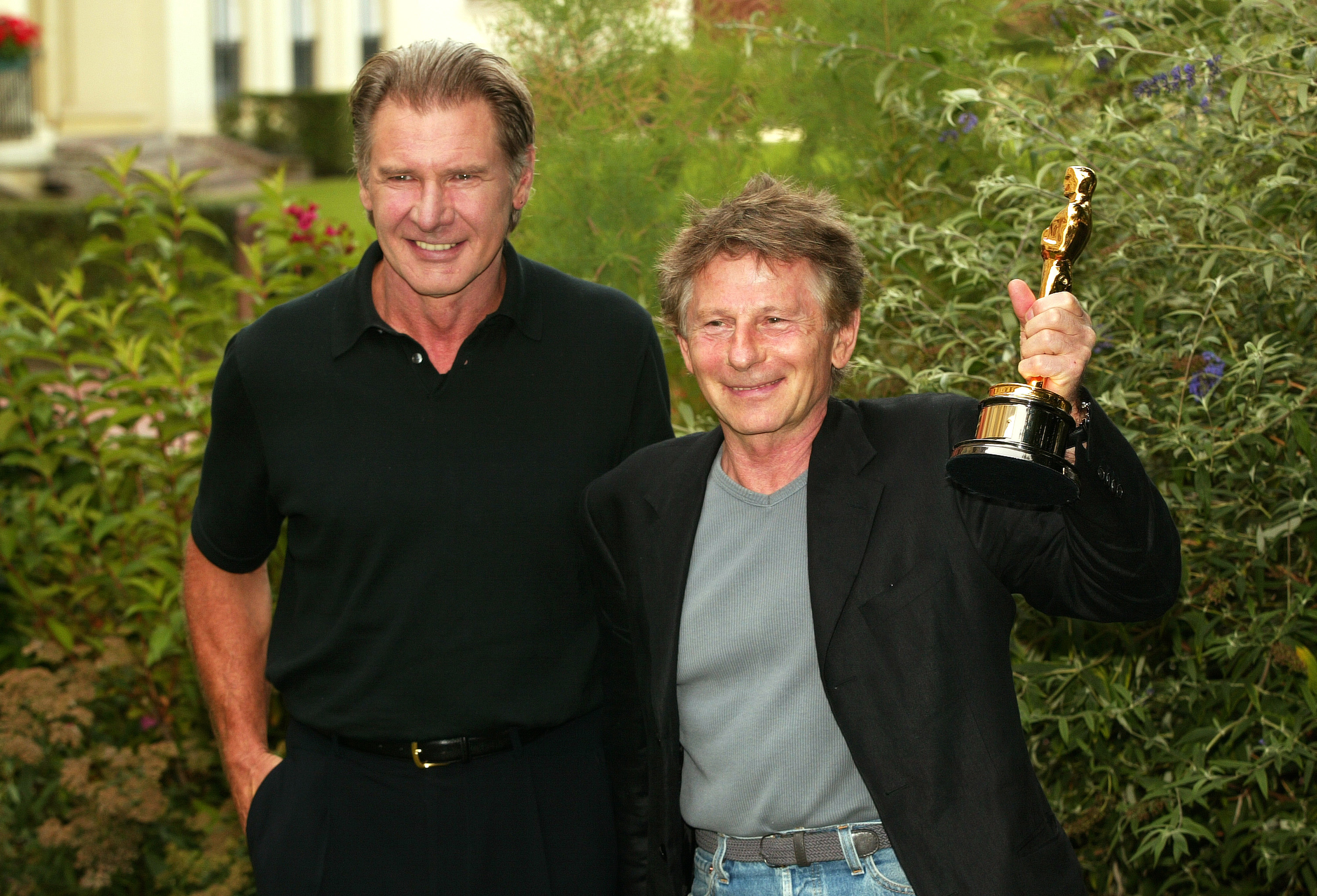 Roman Polanski receives his Oscar from Harrison Ford for the movie "The Pianist" during the 2003 Deauville Film Festival on September 7, 2003 | Source: Getty Images