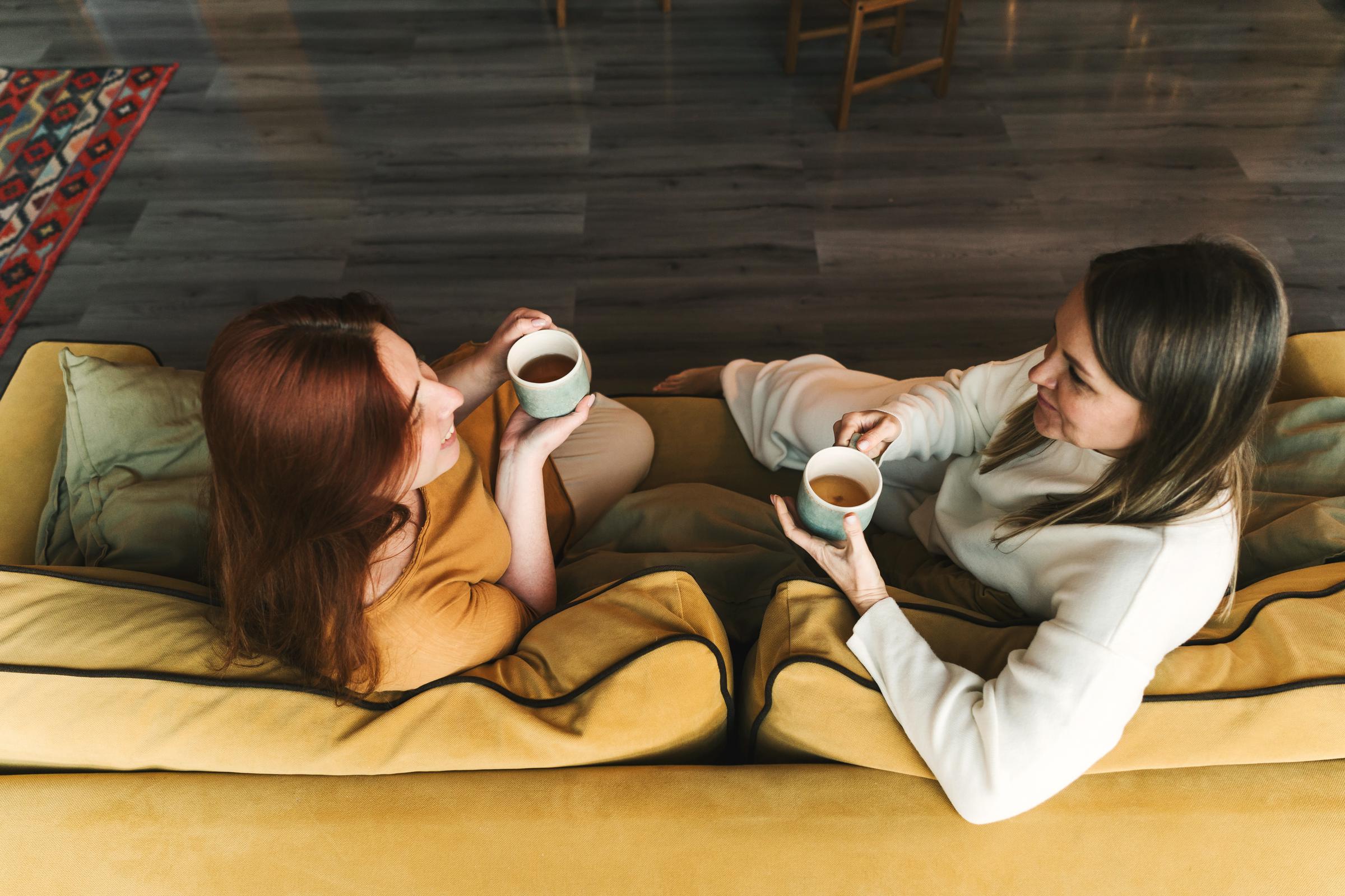 Two women sitting and talking | Source: Getty Images