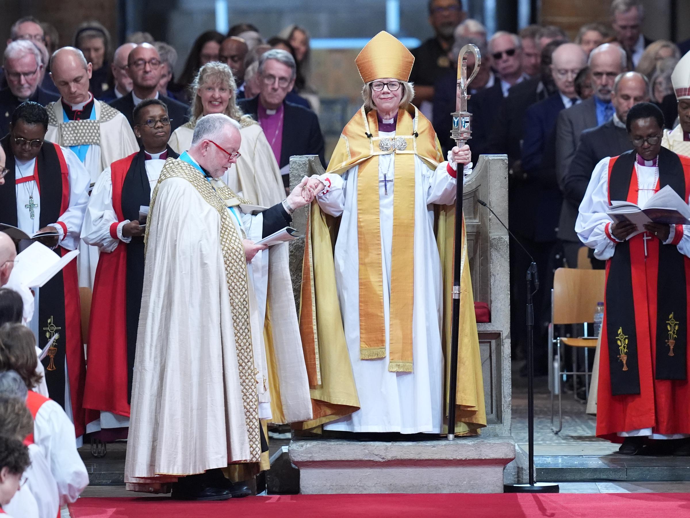 Robed in gold and clutching her pastoral staff, Mullally stood in St. Augustine's Chair — a seat that has held 105 archbishops before her, none of them a woman — as Dean Monteith took her hand during the enthronement at Canterbury Cathedral on 25 March 2026, the congregation packed in behind her as far as the eye could see.