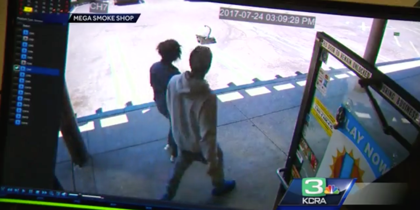 Two men are seen walking near a shop when they suddenly notice a car seat lying in the shopping center's parking area | Source: YouTube.com/KCRA 3