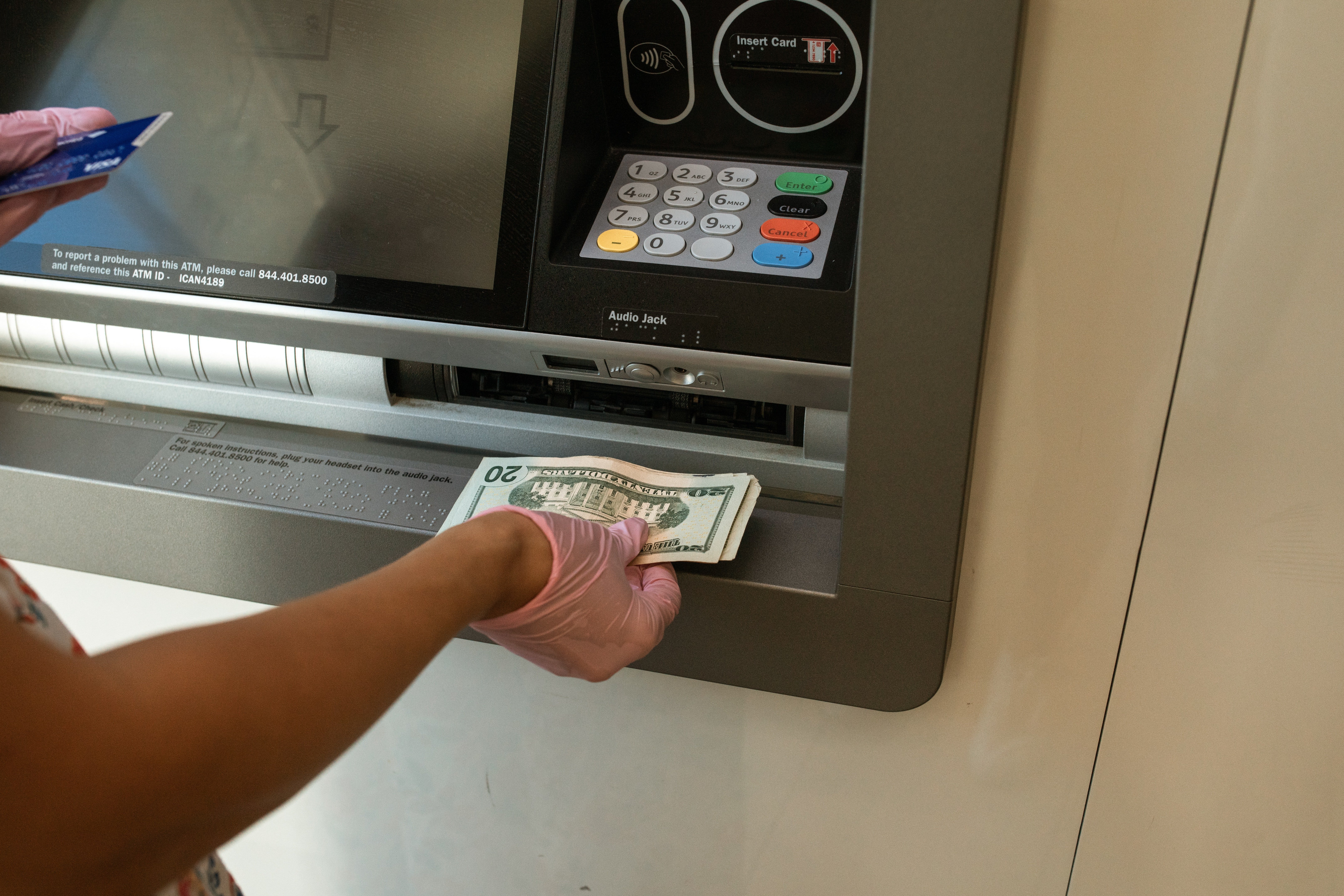 A customer withdrawing monet from an ATM | Source: Pexels