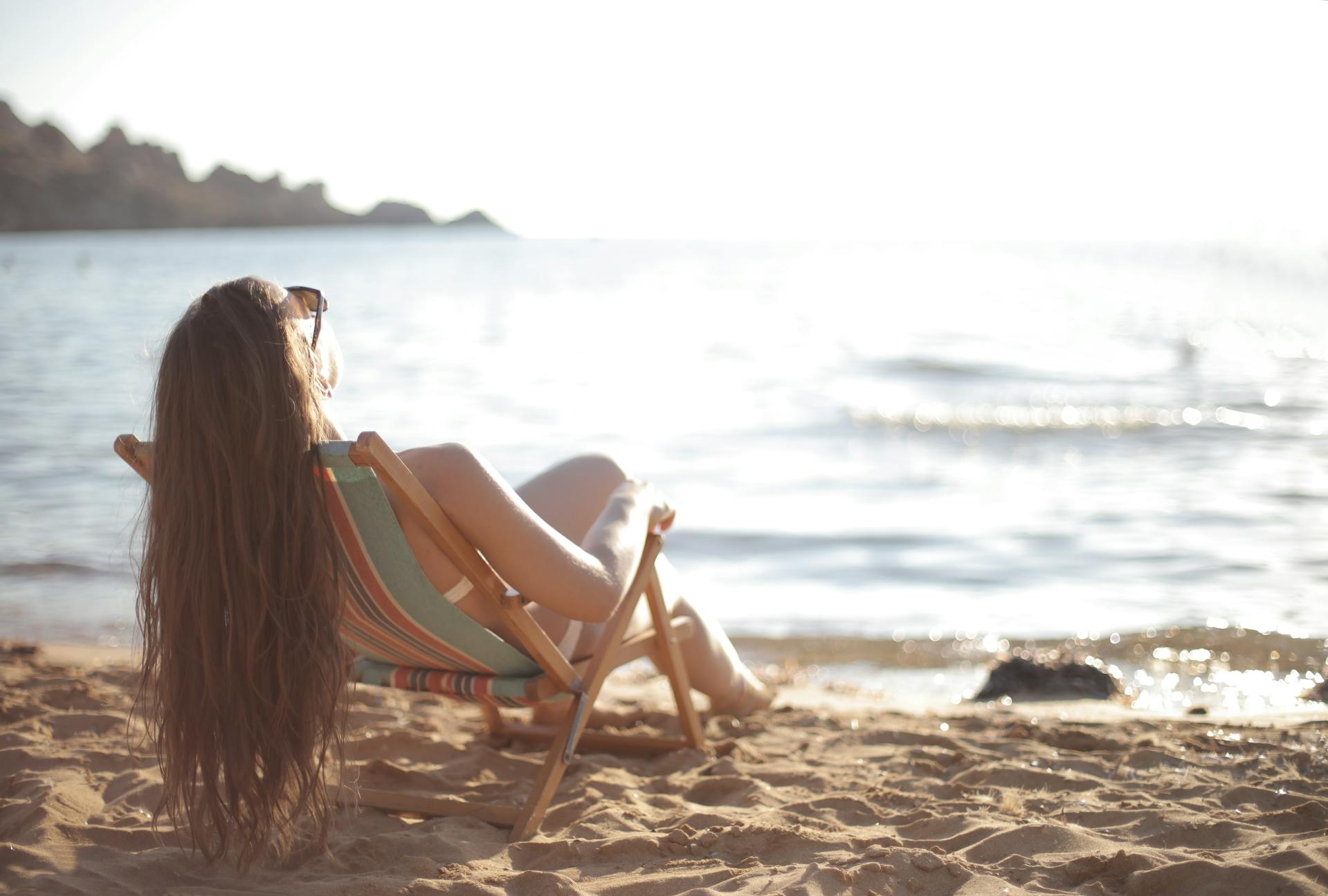 A woman in a swimsuit reclining in a beach chair | Source: Pexels