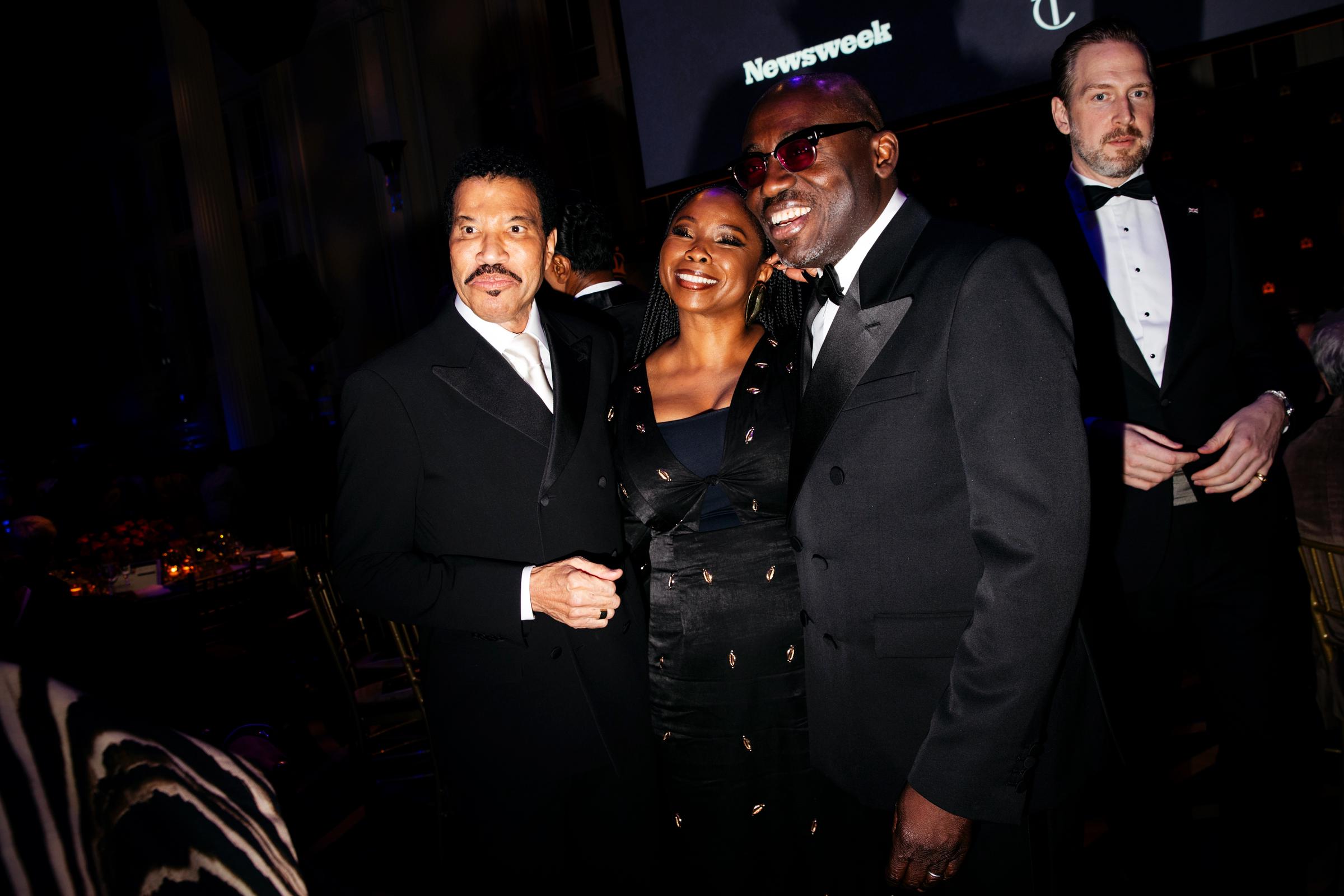 Richie mingles with Eva Omaghomi and Edward Enninful at the King's Trust Gala, looking engaged and enjoying the conversation. Parigi is not in this shot, perhaps giving him space to interact with other guests.