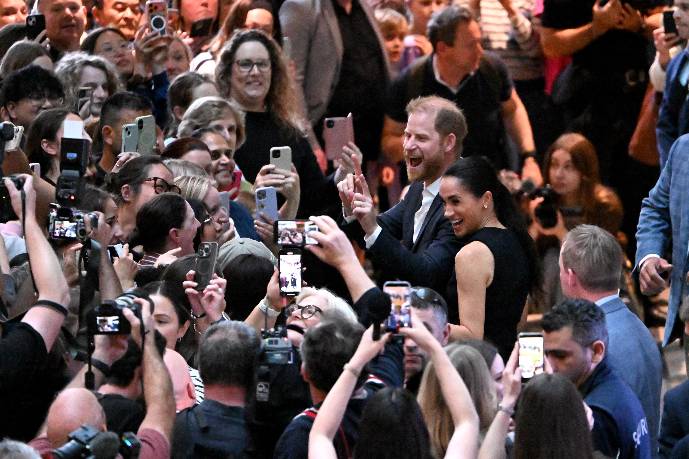 Prince Harry and Meghan Markle were surrounded by a dense crowd of well-wishers as they greeted members of the public during their hospital visit in Melbourne on 14 April 2026. | Source: Getty Images