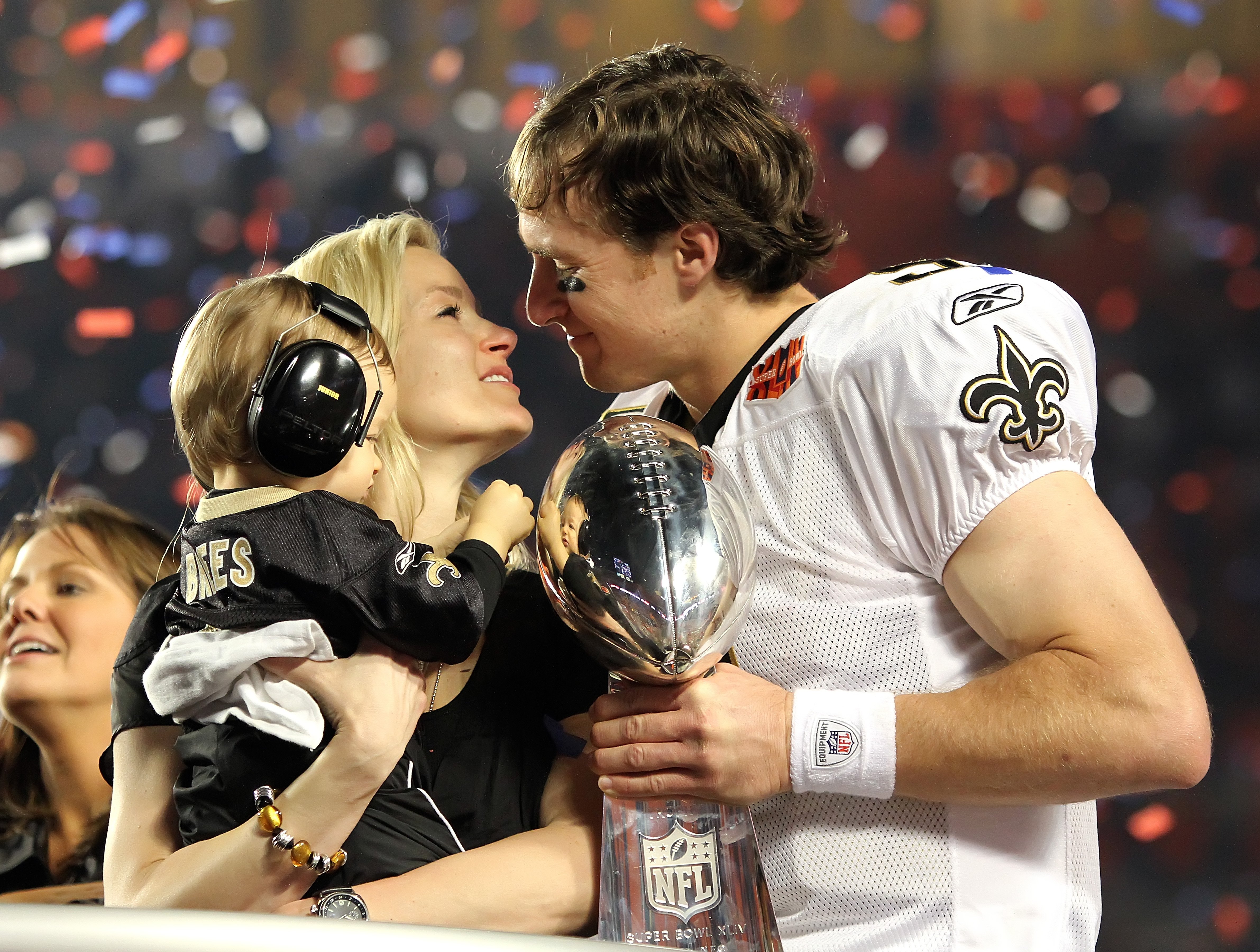New Orleans Saints quarterback Drew Brees celebrates with his wife, Brittany, and son, Baylen, as Colts quarterback Peyton Manning leaves the field as the New Orleans Saints beat the Indianapolis Colts 31-17, Sunday, February 7, 2010 in Super Bowl XLIV at Sun Life Stadium in Miami Gardens, Florida. | Source:  Getty Images