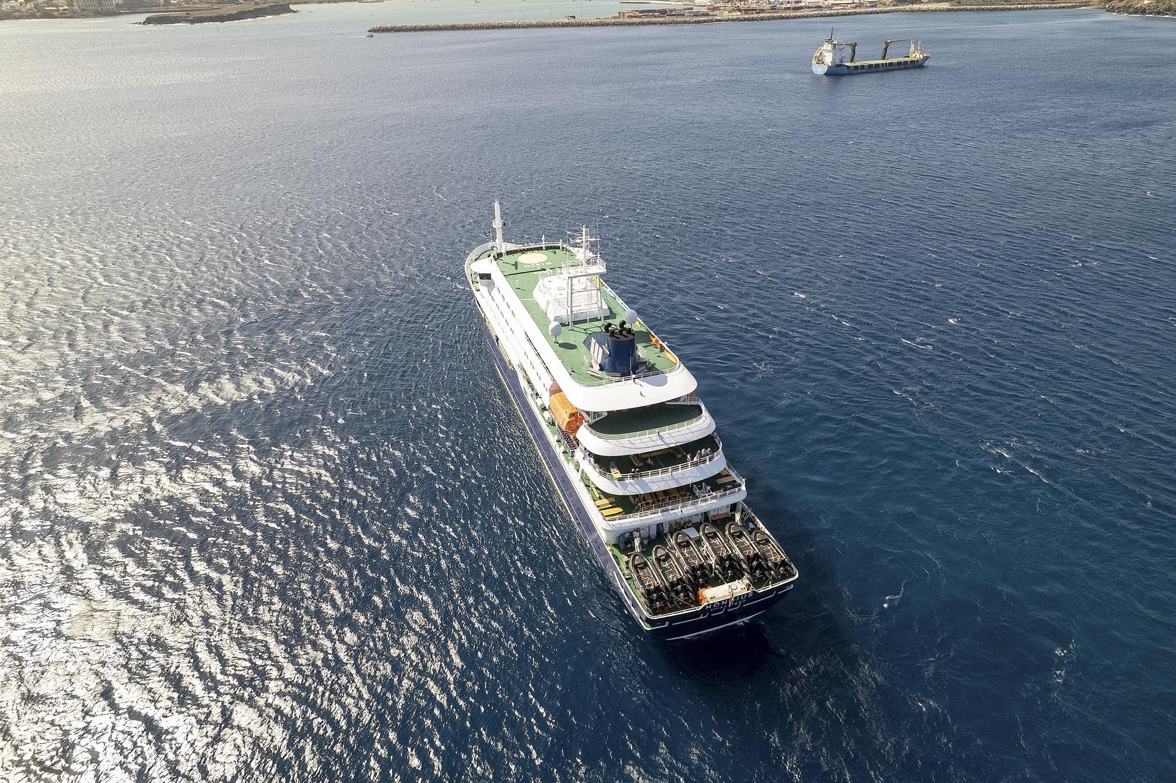 This aerial picture shows a general view of the cruise ship MV Hondius stationary off the port of Praia, the capital of Cape Verde, on 3 May 2026. | Source: Getty Images