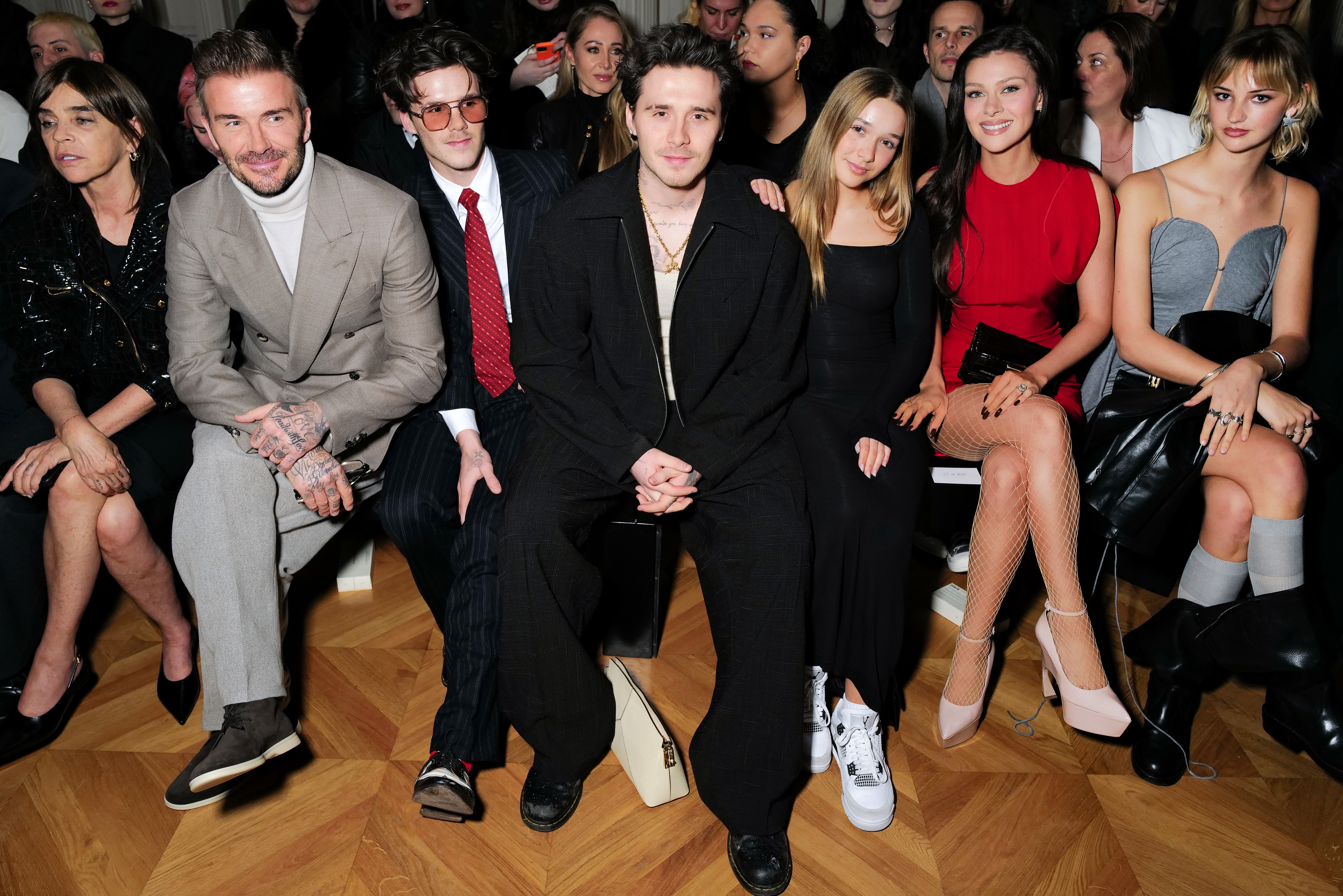David, Cruz, Brooklyn and Harper Beckham, and Nicola Peltz-Beckham attend the Victoria Beckham AW24 show during Paris Fashion Week on March 1, 2024, in Paris, France. | Source: Getty Images