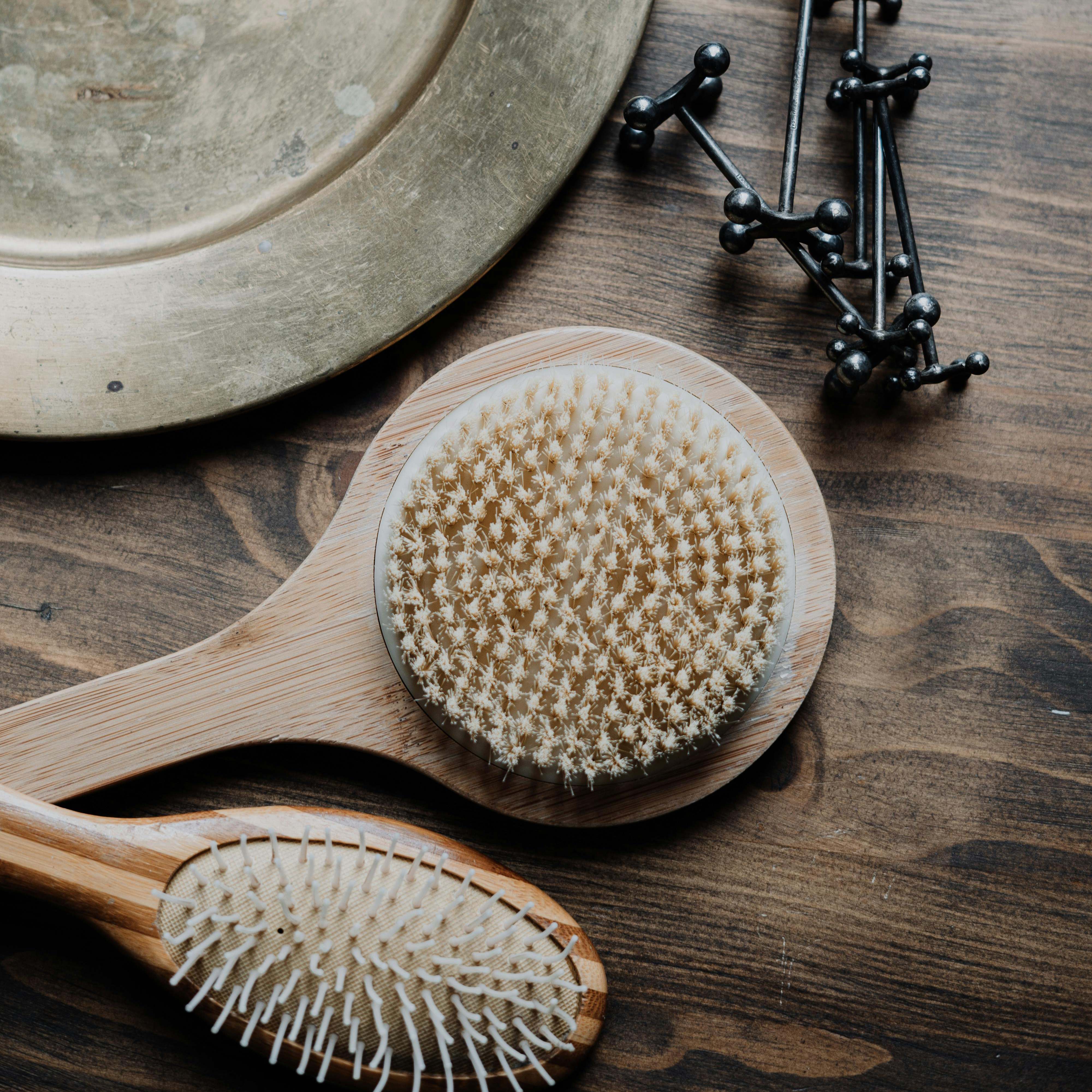 A pair of hair brushes in a bathroom setting | Source: Pexels