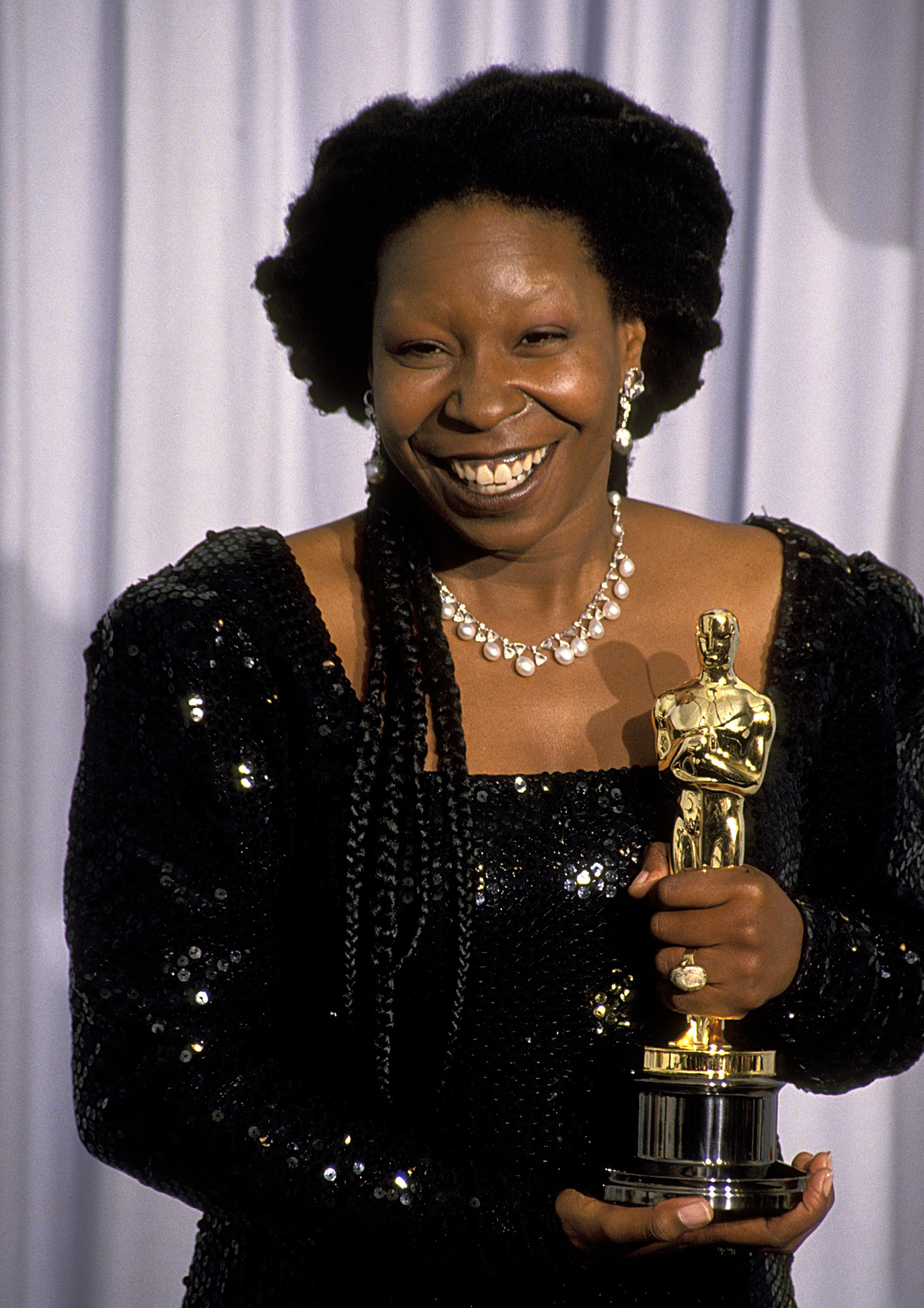 Whoopi Goldberg, with her Oscar for Best Supporting Actress, at the 63rd Annual Academy Awards at the Shrine Auditorium in Los Angeles, California, 25th March 1991 | Source: Getty Images