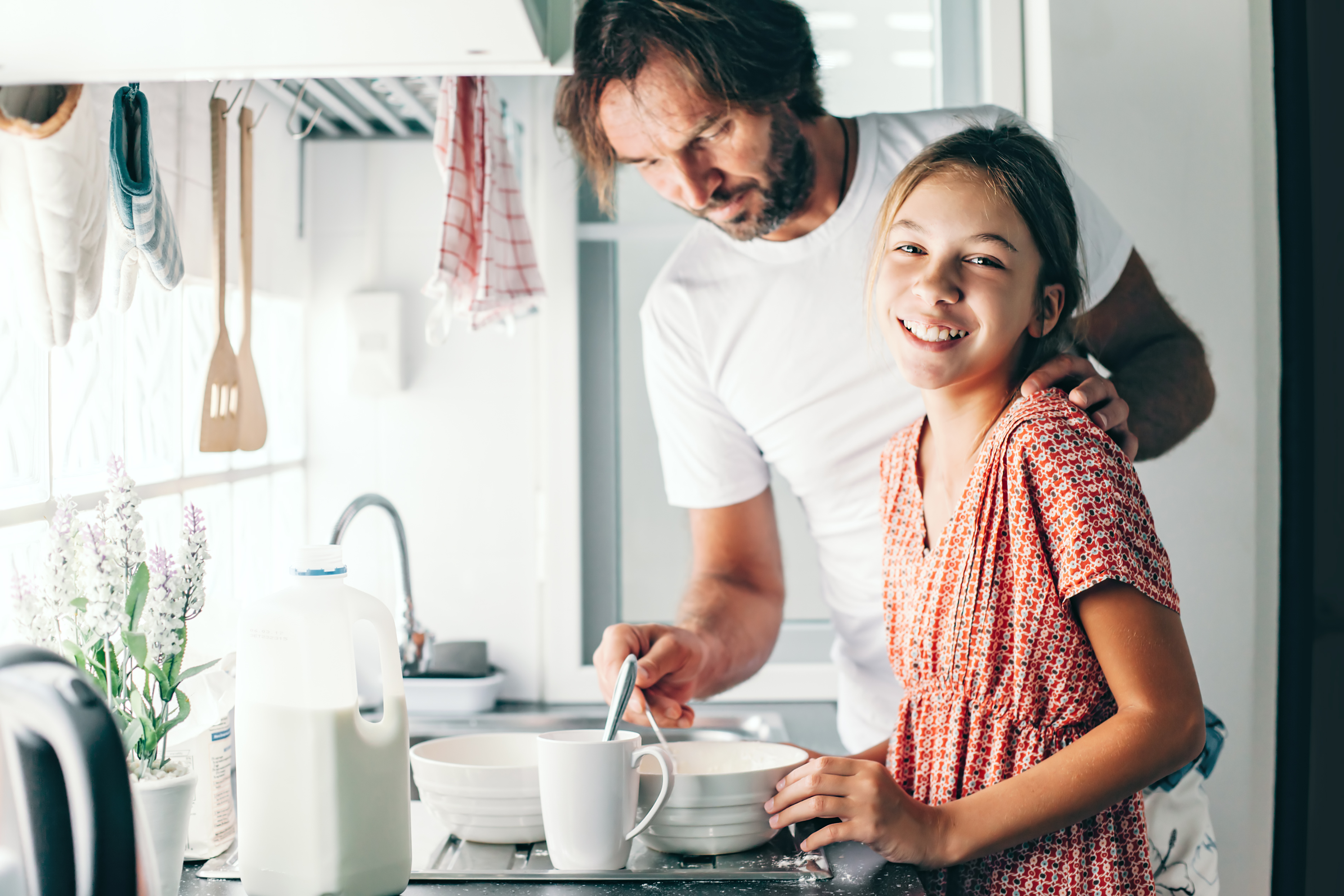 Father and daughter in the kitchen | Source: Shutterstock