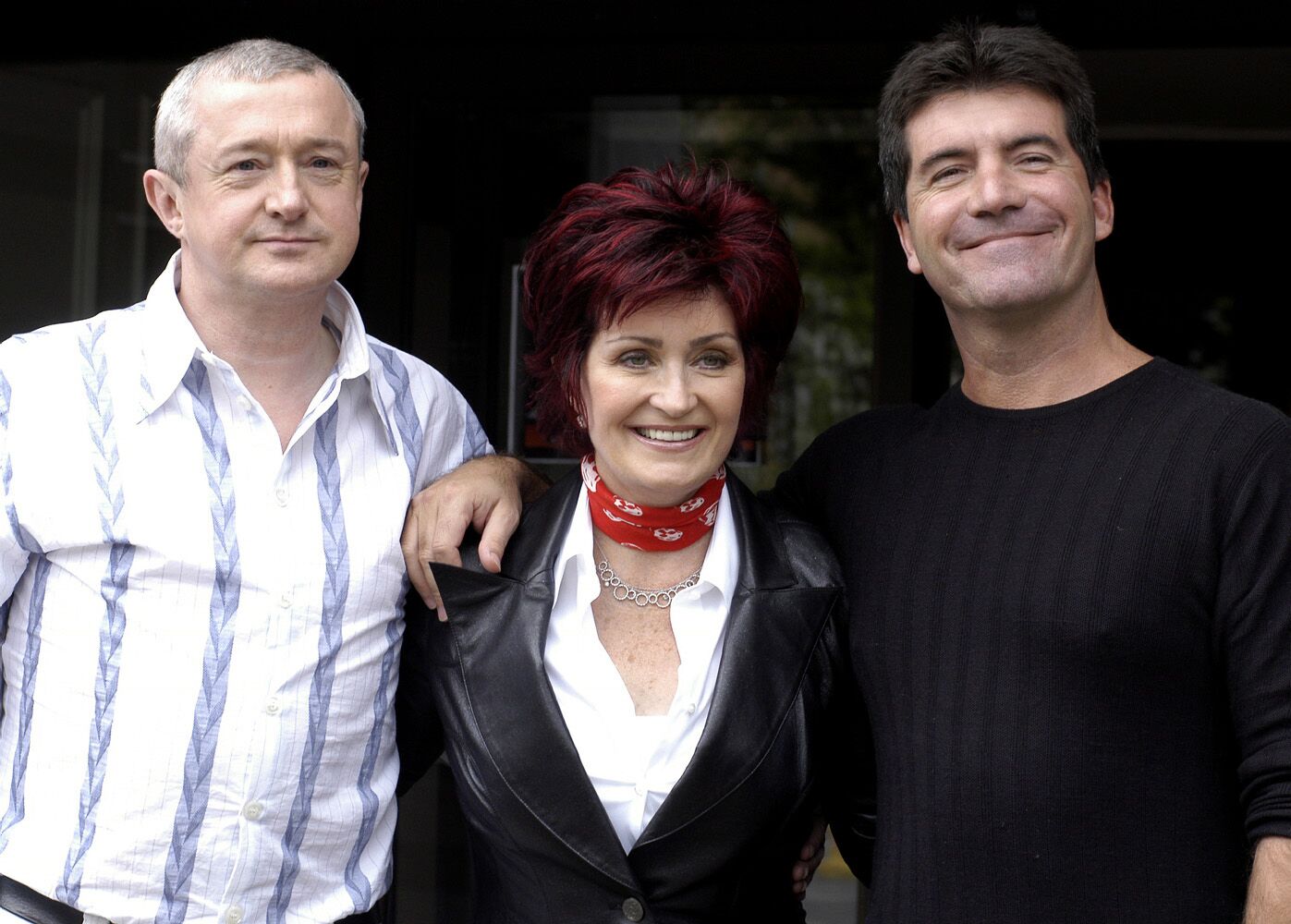 Louis Walsh, Sharon Osbourne and Simon Cowell on set of the TV show "X Factor" in 2004 | Source: Getty Images