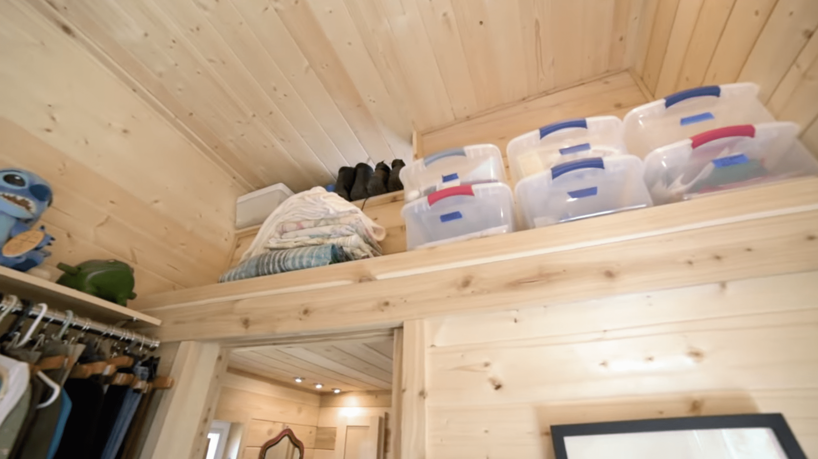 The high ceilings come with extra storage to hold miscellaneous items. | Source: YouTube.com/TinyHomeTours