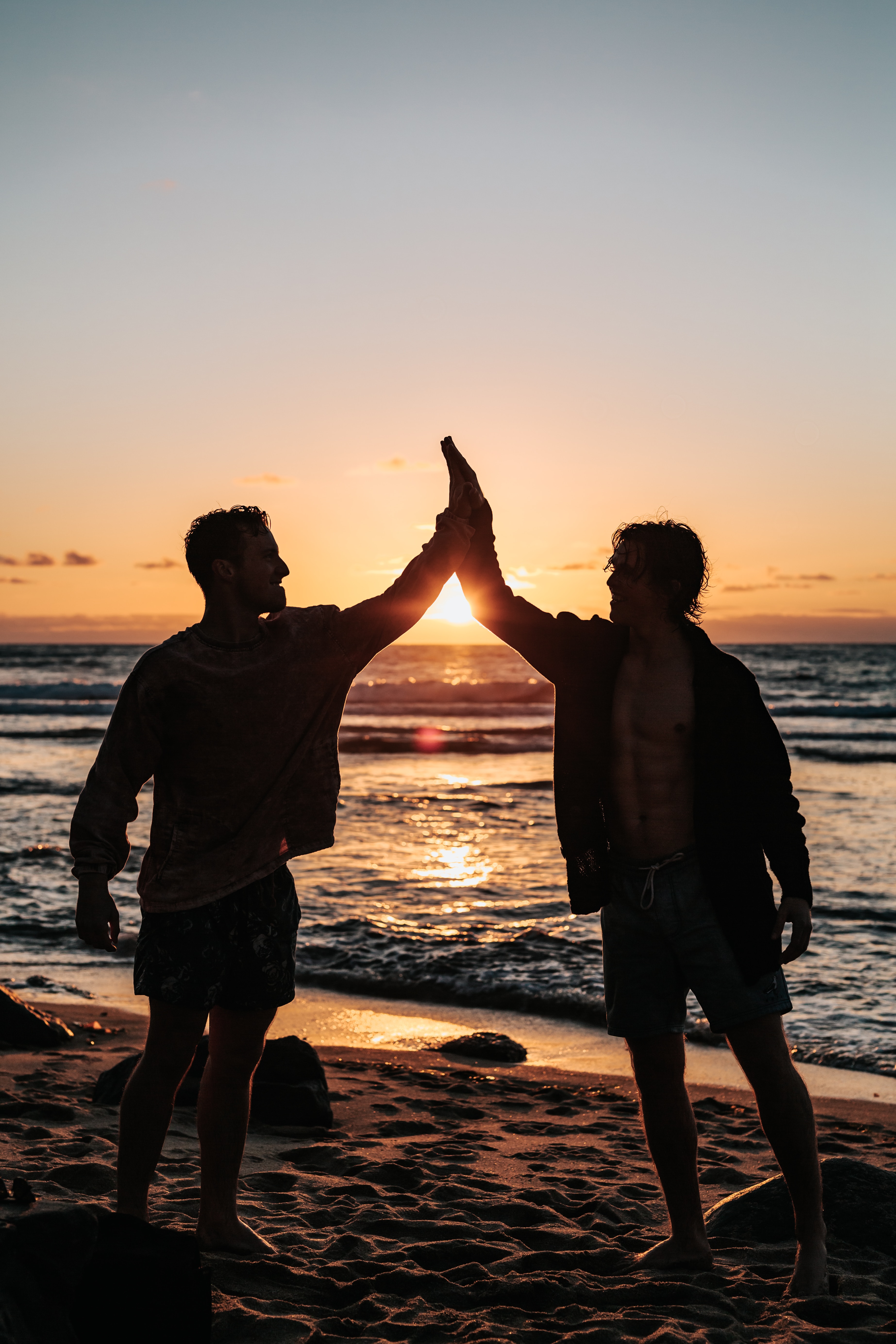 Two men at the beach during sunset | Source: Unsplash