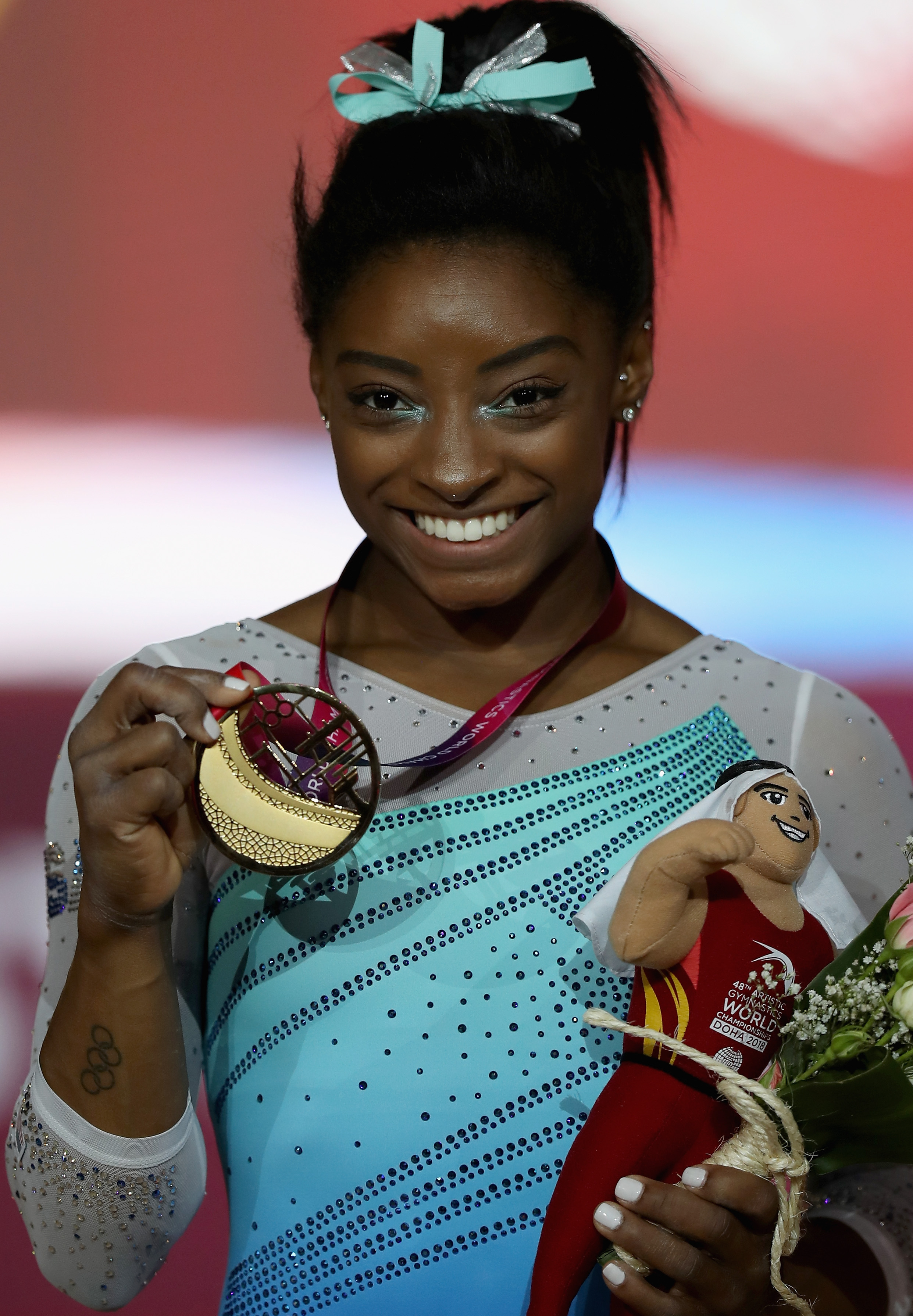 Simone Biles poses for a photograph with her gold medal after winning the Women's All-Round Final at the FIG Artistic Gymnastics Championships on November 1, 2018, in Doha, Qatar | Source: Getty Images