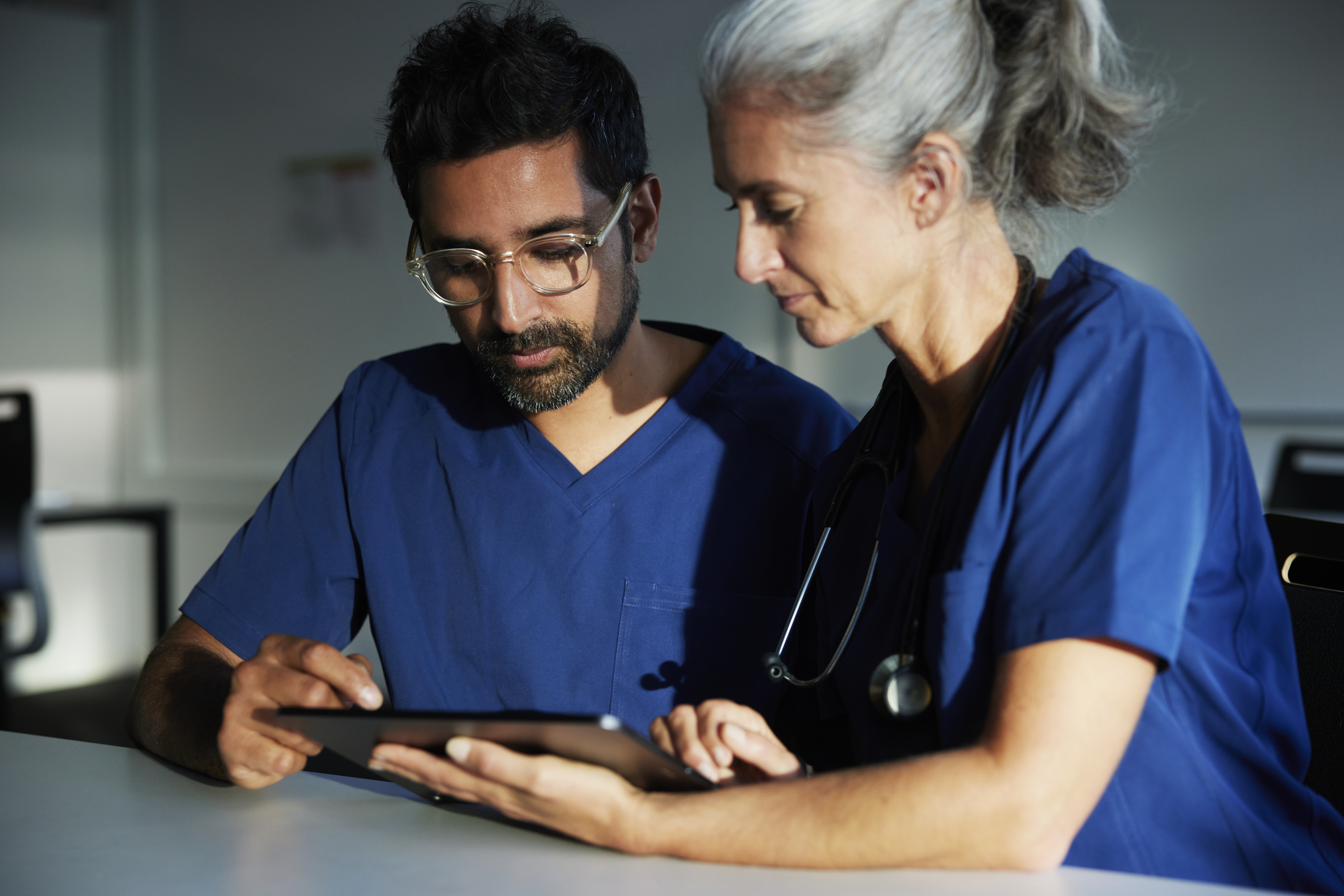 A doctor and nurse looking over files | Source: Getty Images