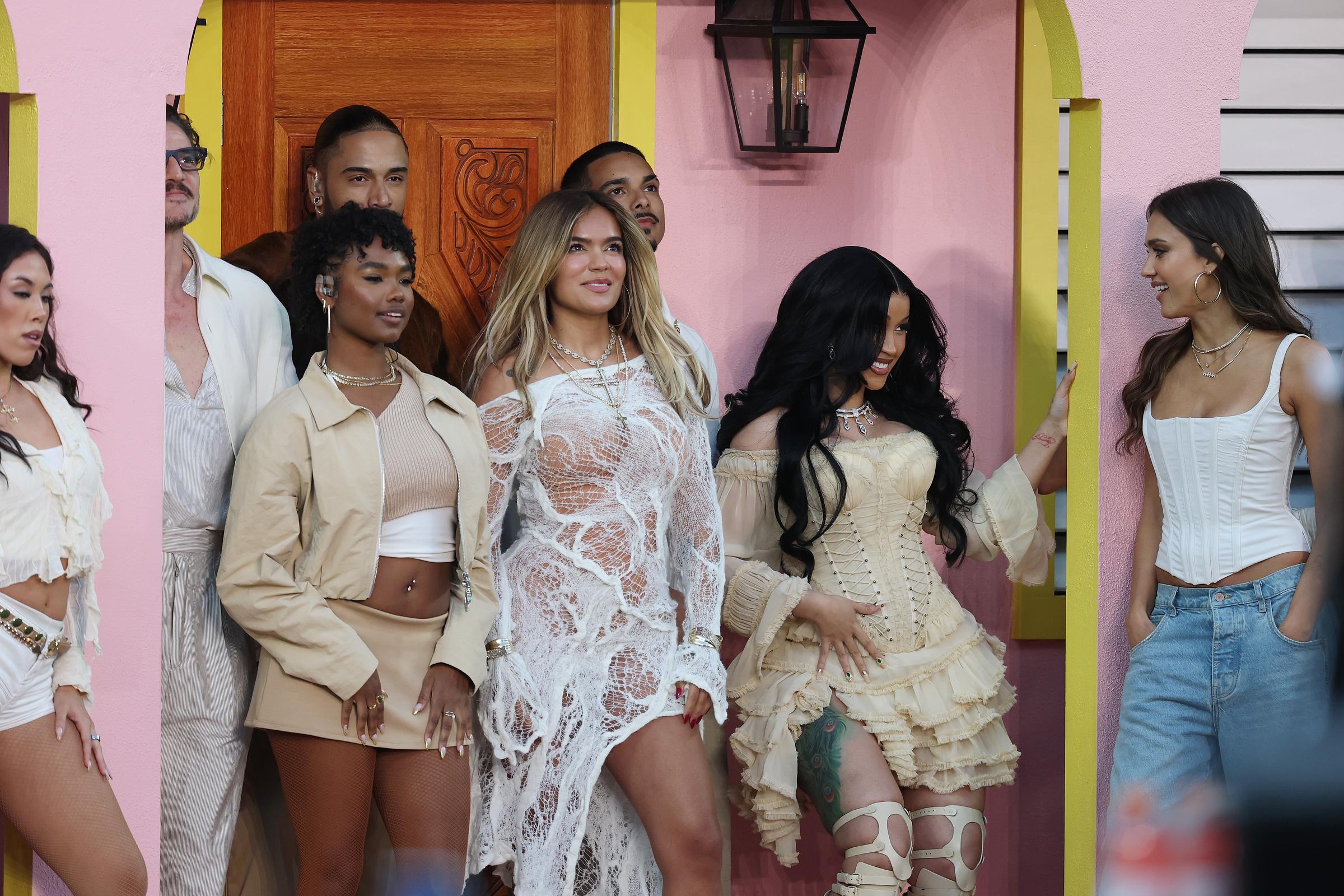 Cardi B smiling beside Jessica Alba, Karol G and Pedro Pascal during the 2026 Super Bowl Halftime Show. | Source: Getty Images