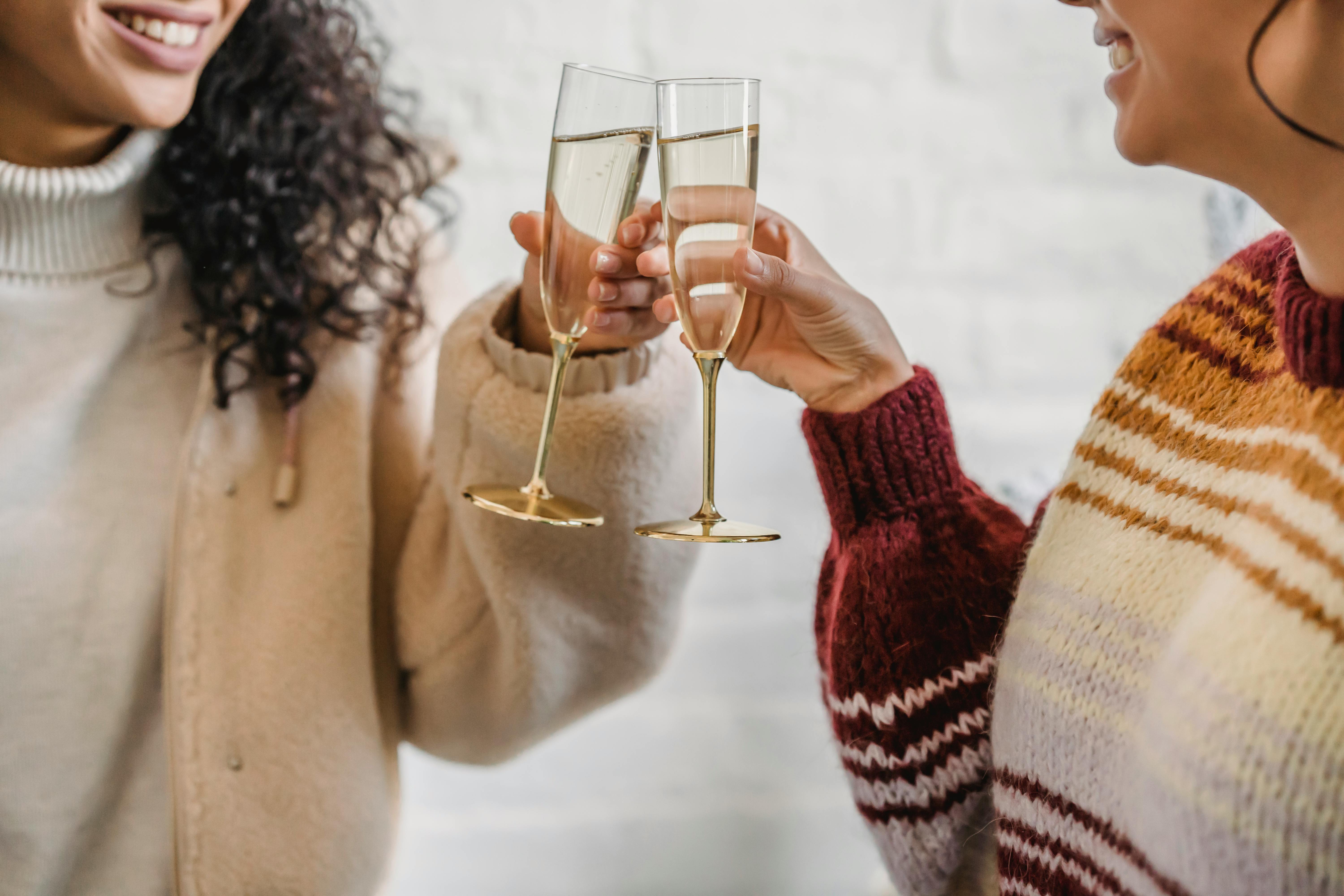 Two friends celebrating with a toast | Source: Pexels