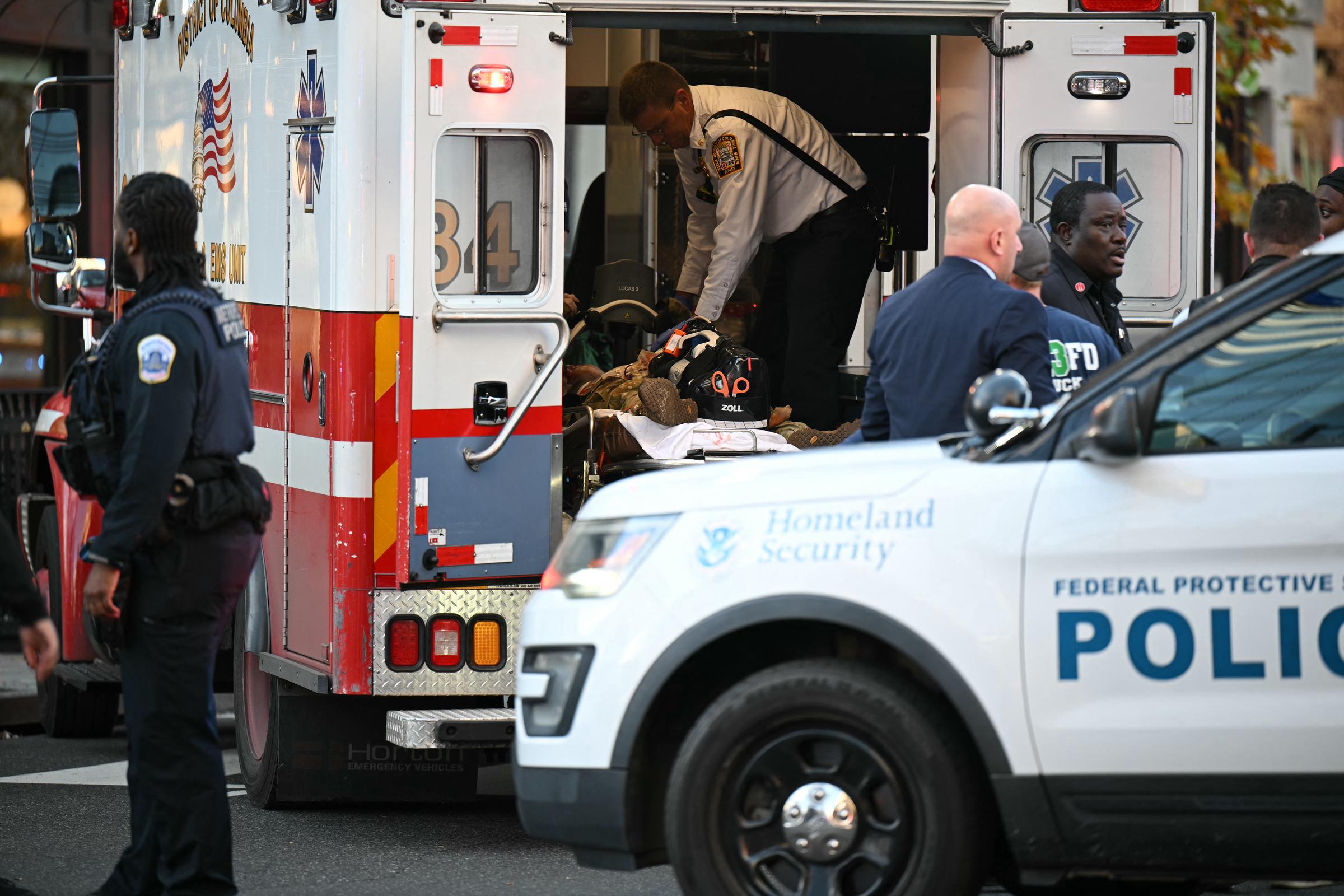 An unidentified man in military uniform lies on a stretcher inside an ambulance on November 26, 2025 in downtown Washington, DC | Source: Getty Images