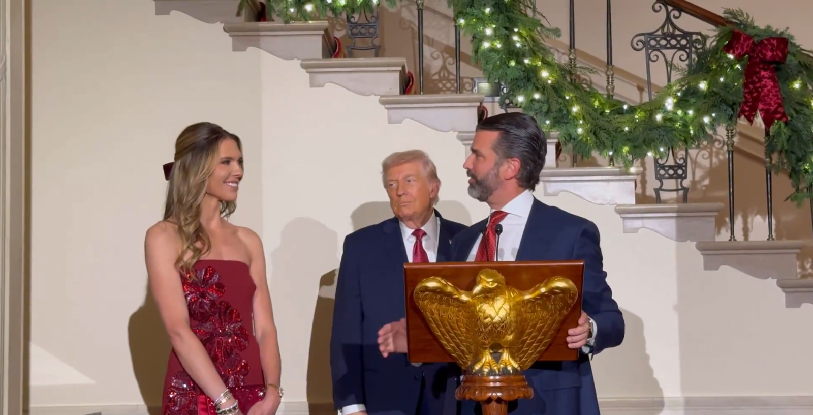 Donald Trump Jr. and his fiancée Bettina Anderson and President Donald Trump at the White House holiday event on December 15, 2025 | Source: X/LauraLoomer