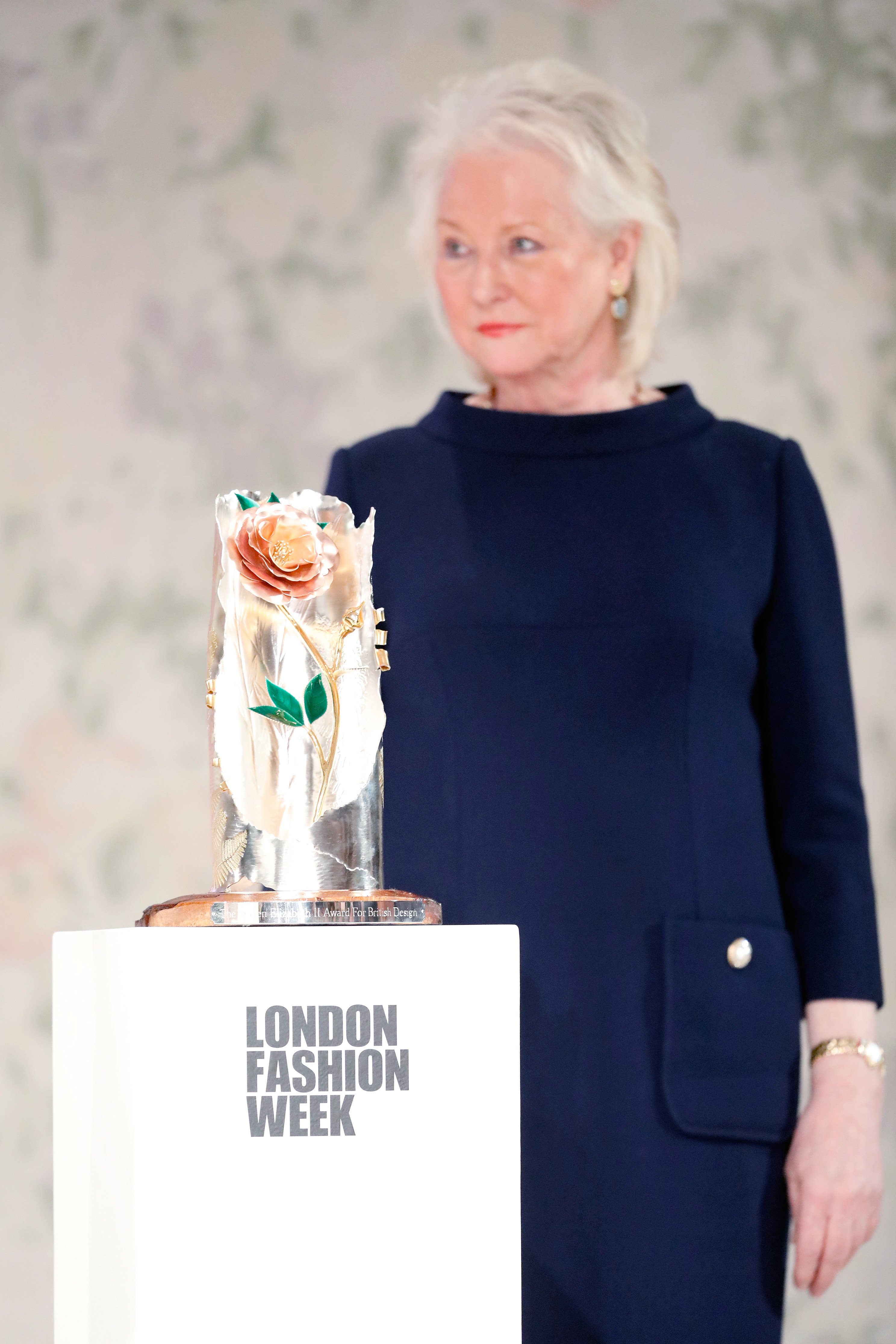 Royal dressmaker Angela Kelly poses with the Inaugural Queen Elizabeth II award for British Design at London Fashion Week on February 20, 2018 in London, England ┃Source: Getty Images