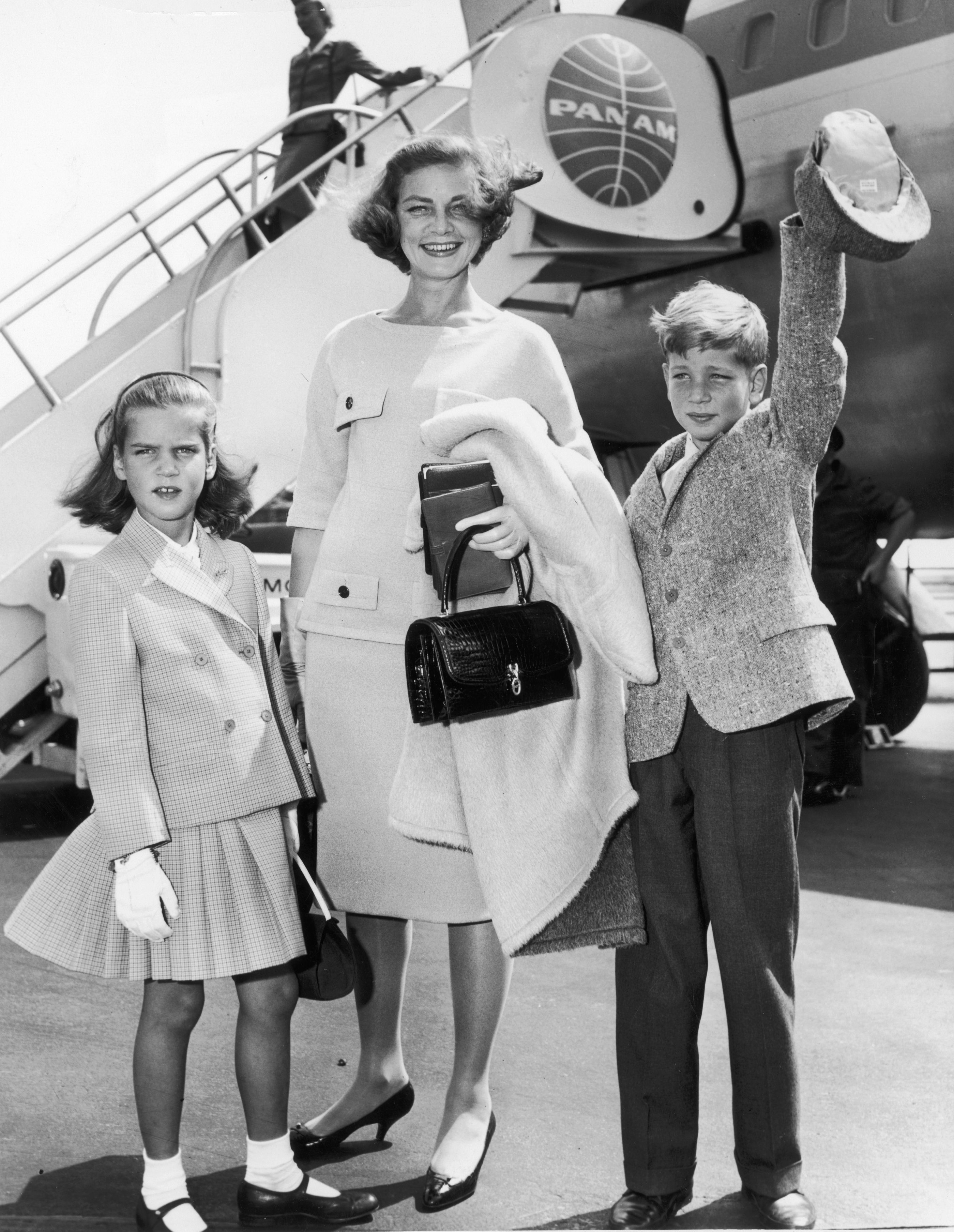 Lauren Bacall smiling with her children Leslie and Stephen Bogart at New York International Airport in New York City, circa 1961. | Source: Hulton Archive/Getty Images