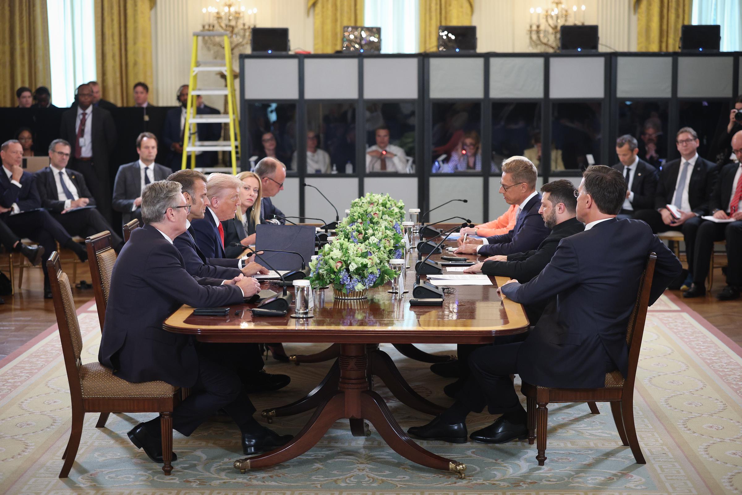 President Donald Trump sits across the table from Ukrainian President Volodymyr Zelenskyy, and European leaders during a meeting at the White House in Washington, DC on August 18, 2025 | Source: Getty Images