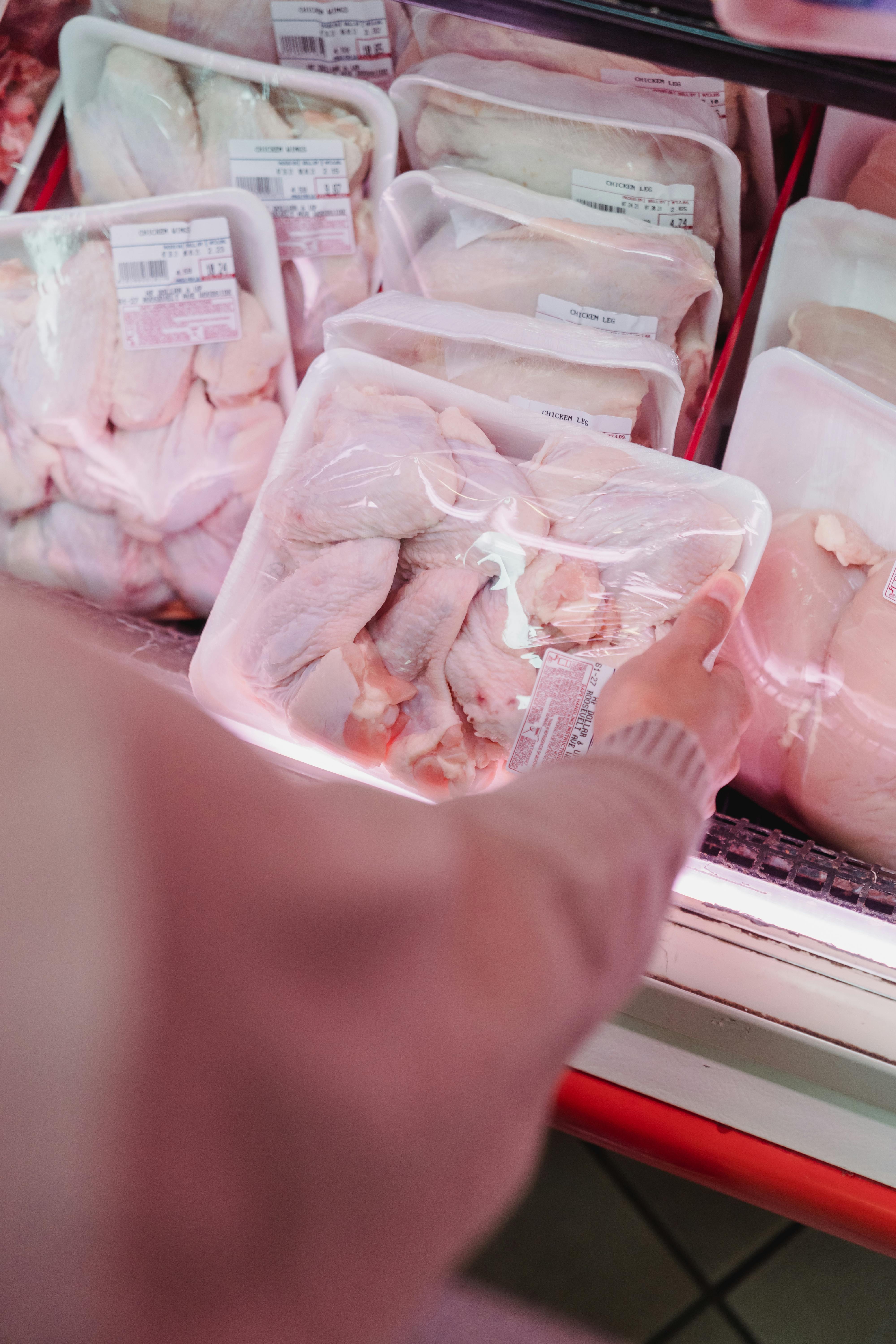 Picking meat at a store | Source: Pexels