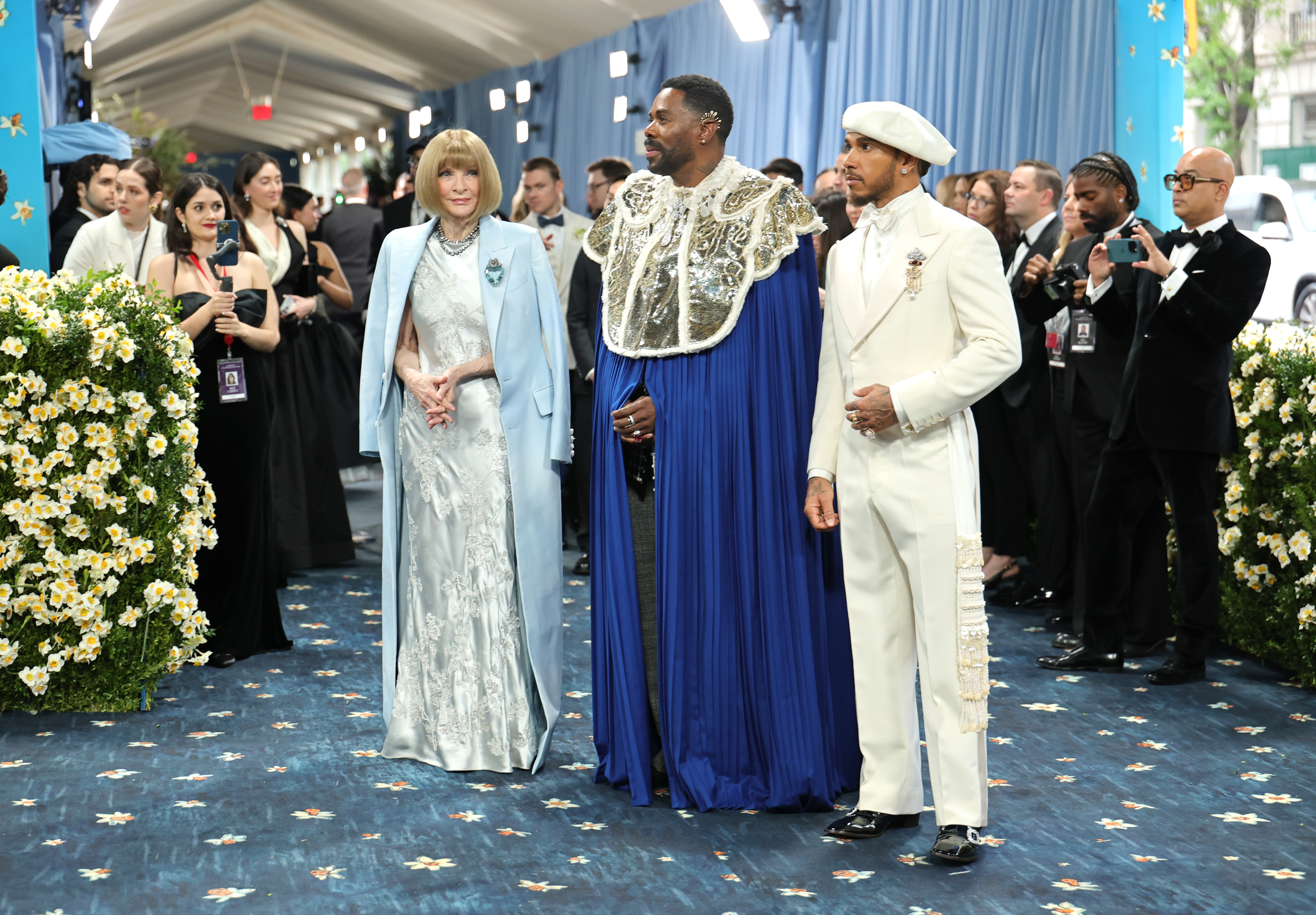 Anna Wintour, Colman Domingo, and Lewis Hamilton pose together at the 2025 Met Gala, representing leadership for the evening's celebration of "Superfine: Tailoring Black Style" at the Metropolitan Museum of Art.