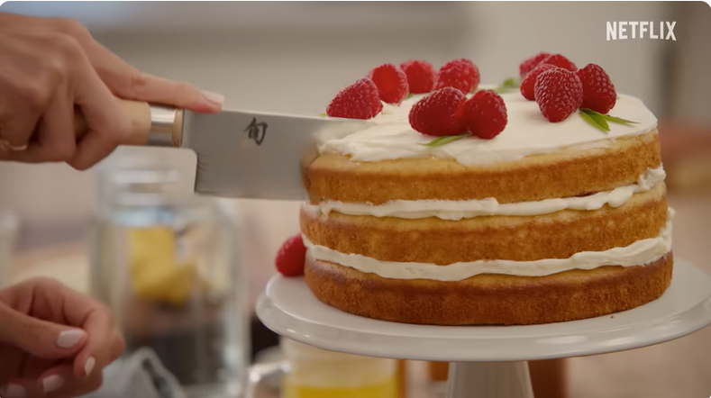 Meghan Markle cutting a cake in the trailer for her lifestyle show on Netflix "With Love, Meghan," from a post dated January 2, 2025 | Source: Youtube/Netflix