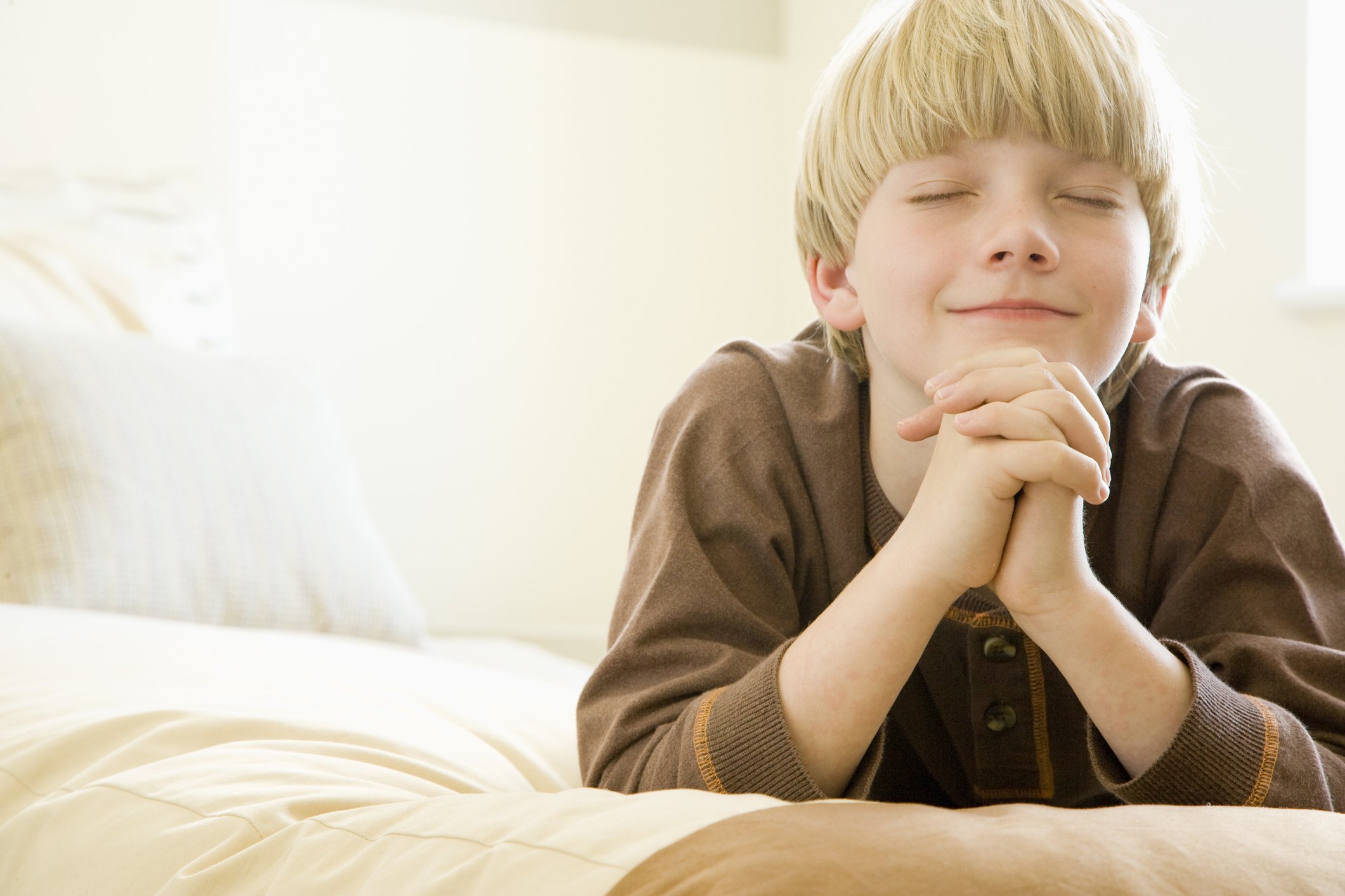 Boy praying before bed |Photo: Getty Images