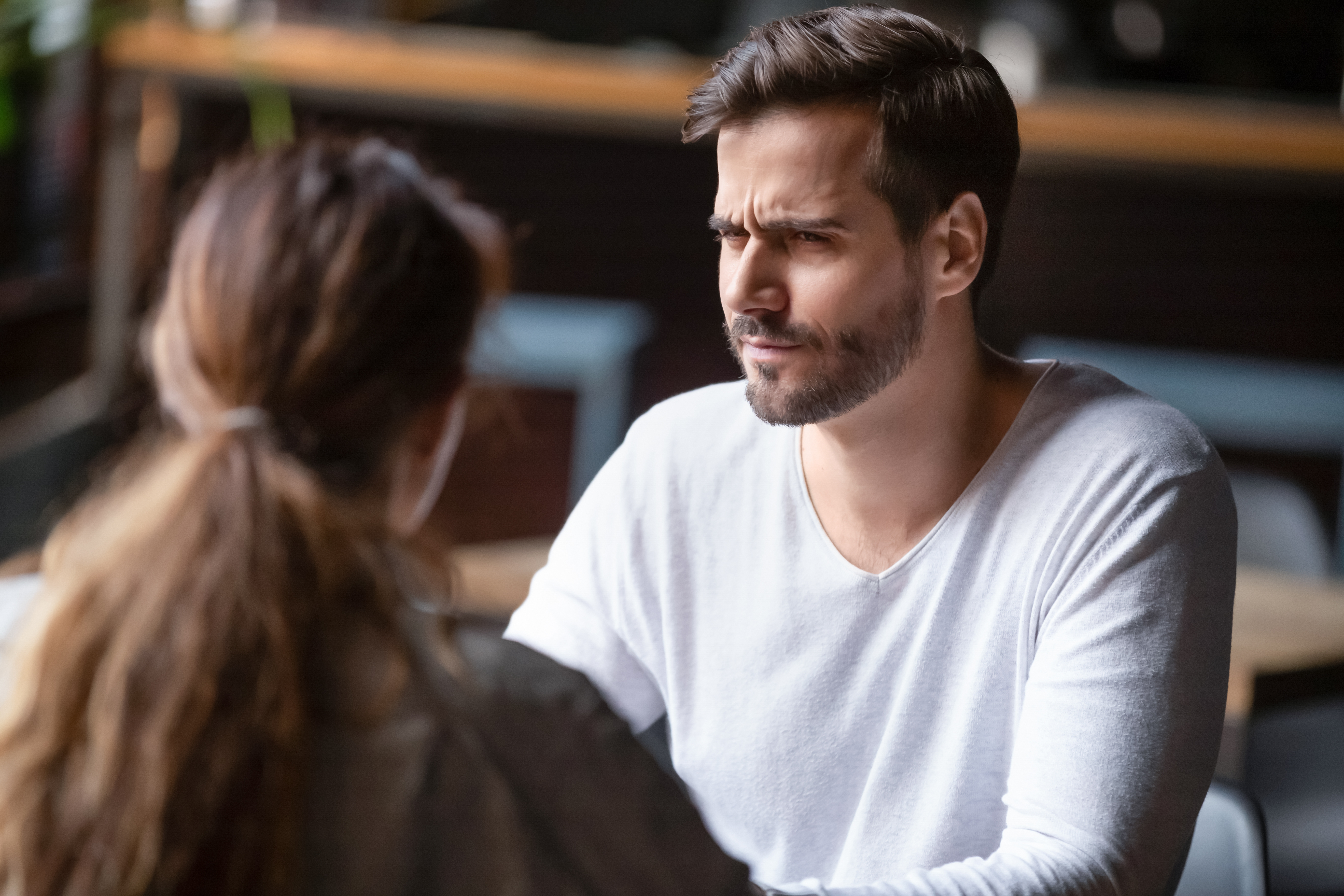 A man looking upset while listening to his partner | Source: Shutterstock