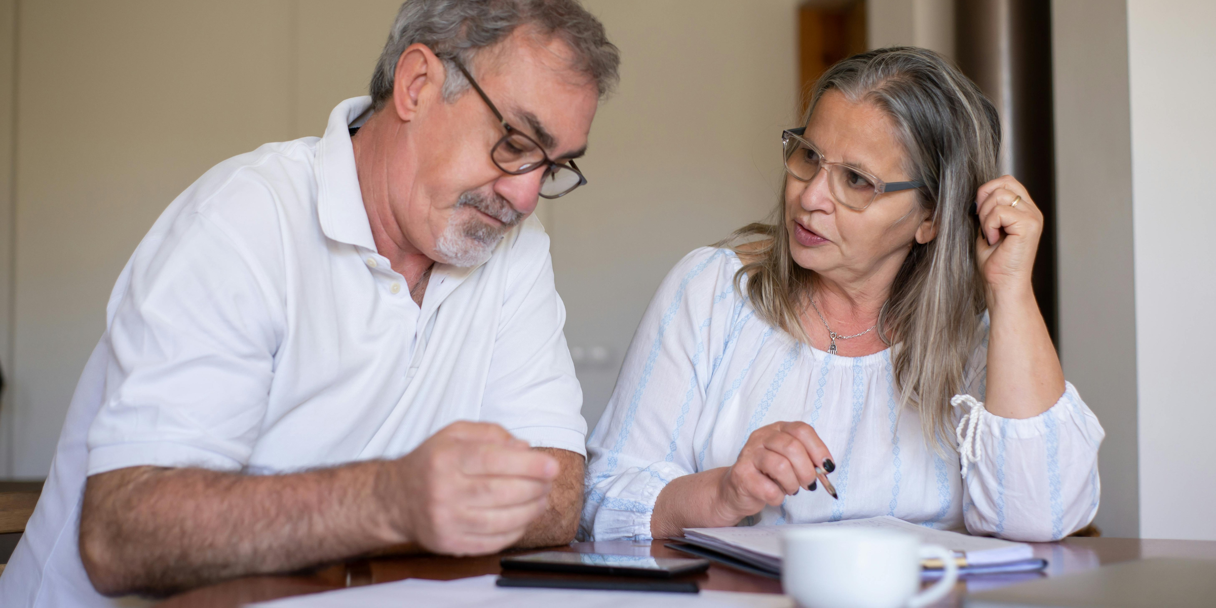 A man and woman fixing documents | Source: Pexels