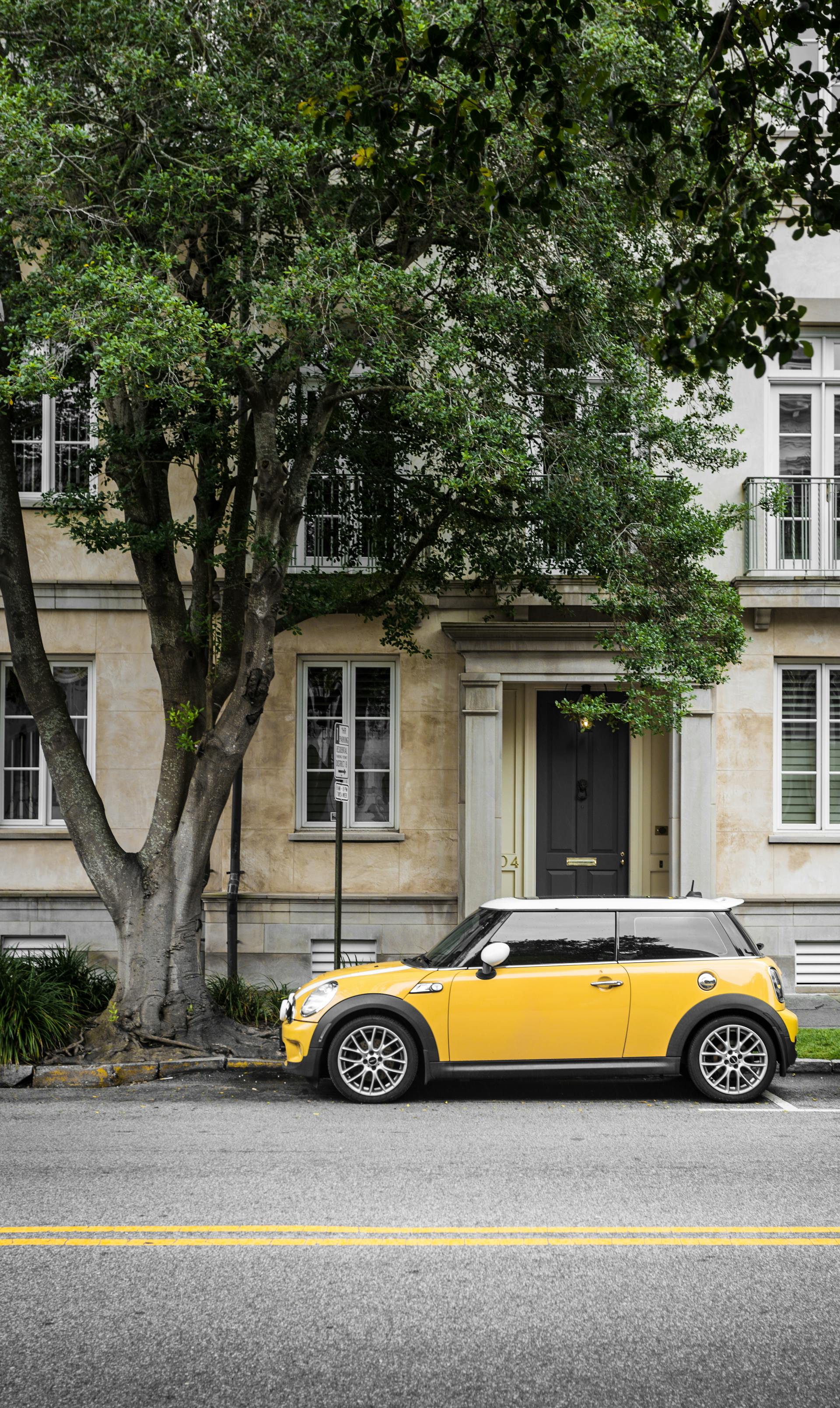 A yellow car parked alongside the road | Source: Pexels