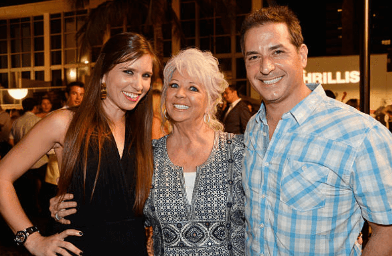 Claudia Deen, Paula Deen, and Bobby Deen pose together during an appearance at the "Thrillist's BBQ & The Blues" for the Food Network South Beach Wine & Food Festival, on February 22, 2014, in Miami Beach, Florida | Source: Frazer Harrison/Getty Images for Food Network SoBe Wine & Food Festival