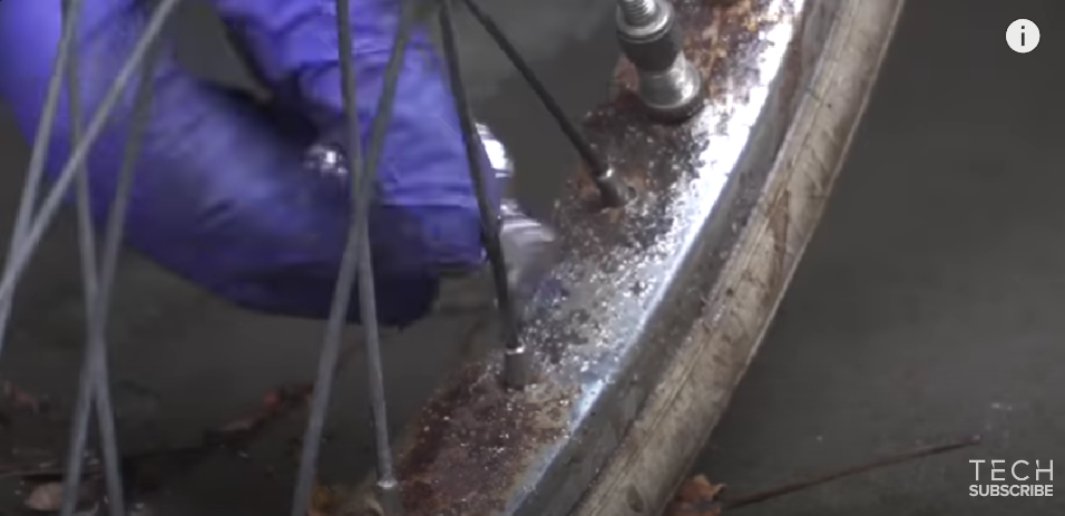 A person cleaning rust off a bicycle | Source: YouTube/GCN Tech