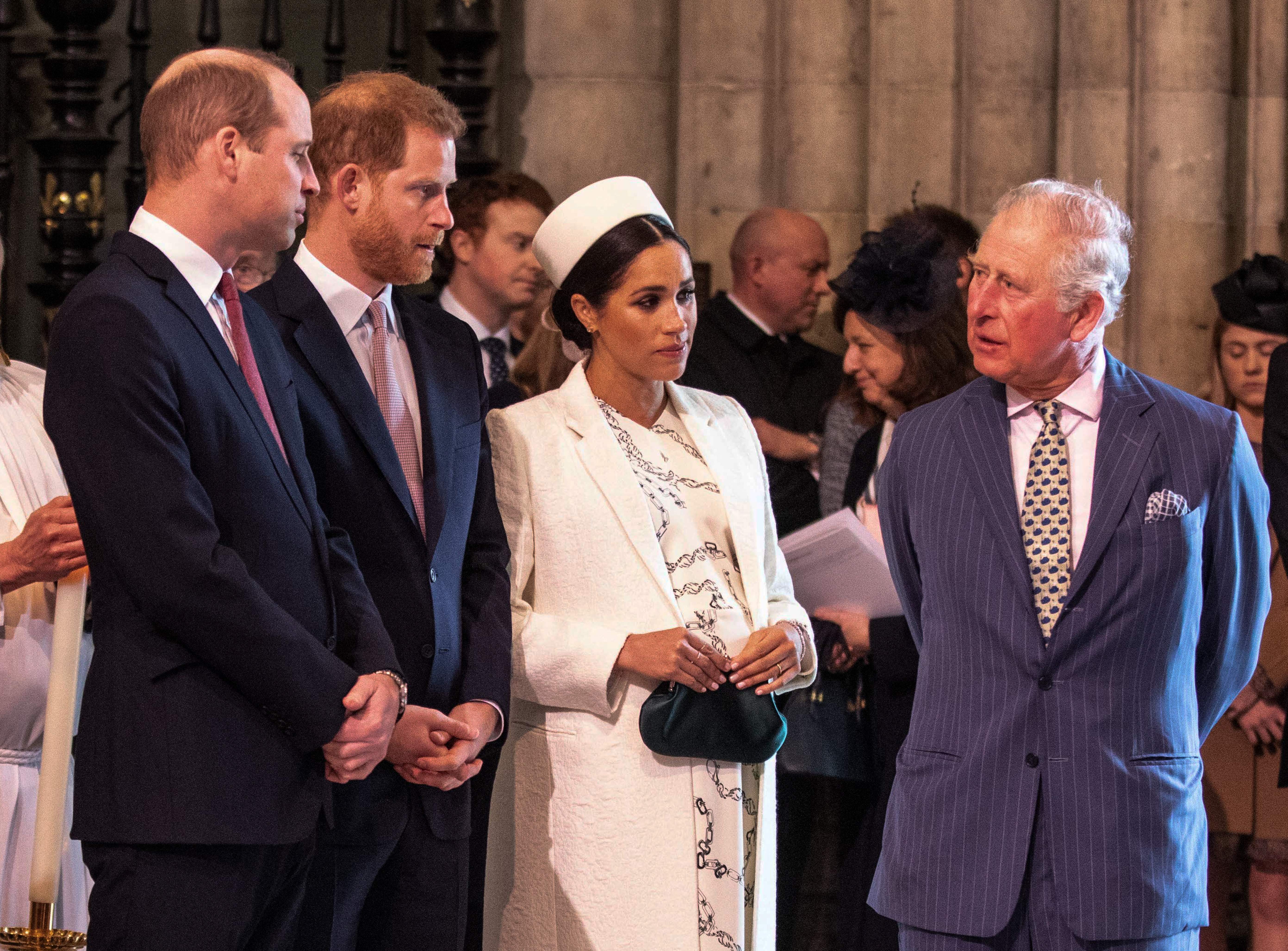Prince William, Prince Harry, Meghan Markle, Duchess of Sussex, talk with King Charles III as they attend the Commonwealth Day service on March 11, 2019 in Westminster Abbey, London.