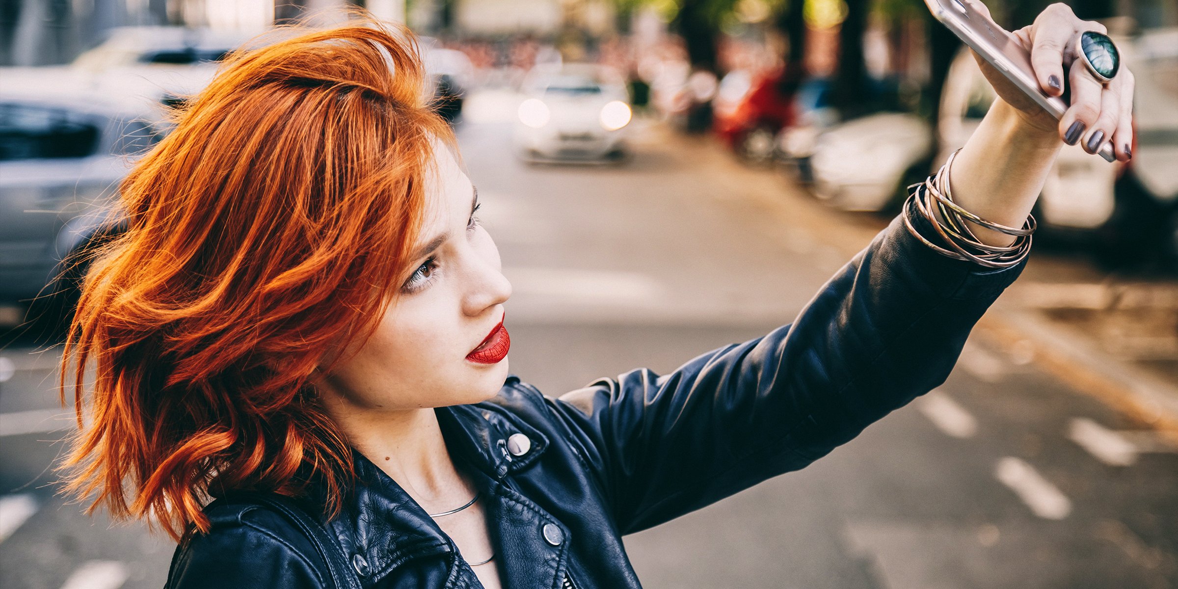 A Woman with Copper-Colored Hair Is Pictured Taking a Selfie | Source: Shutterstock