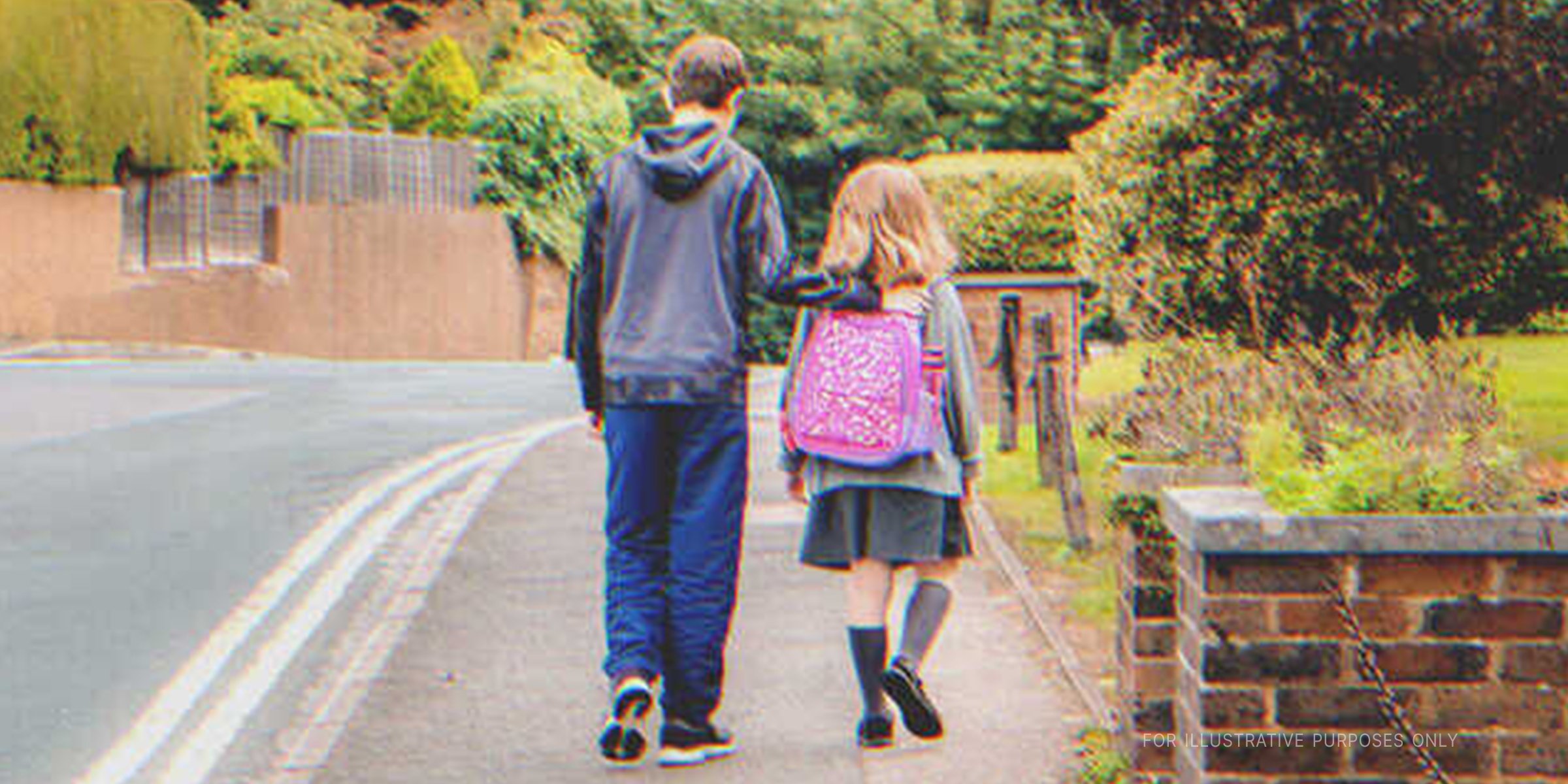 An older boy and young girl walking together | Source: Shutterstock 