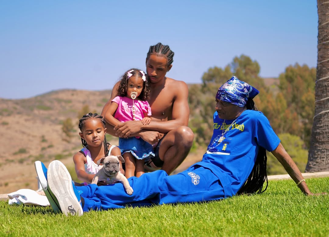 Snoop Dogg with his son and granddaughters on the grass, dated July 2025 | Source: Instagram/snoopdogg