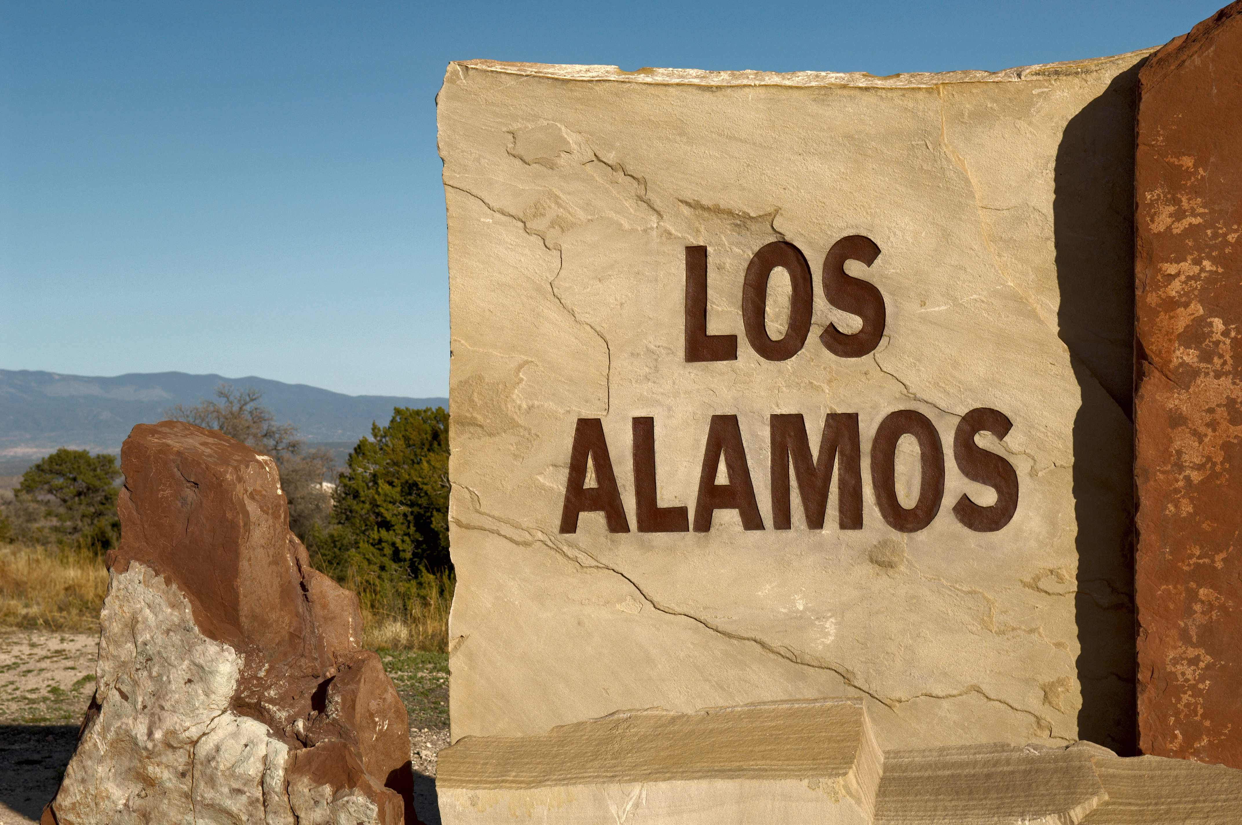 A carved and painted stone sign at the entrance to the town of Los Alamos, New Mexico, home to the Los Alamos National Laboratory, and birthplace of the Atomic Bomb. | Source: Getty Images