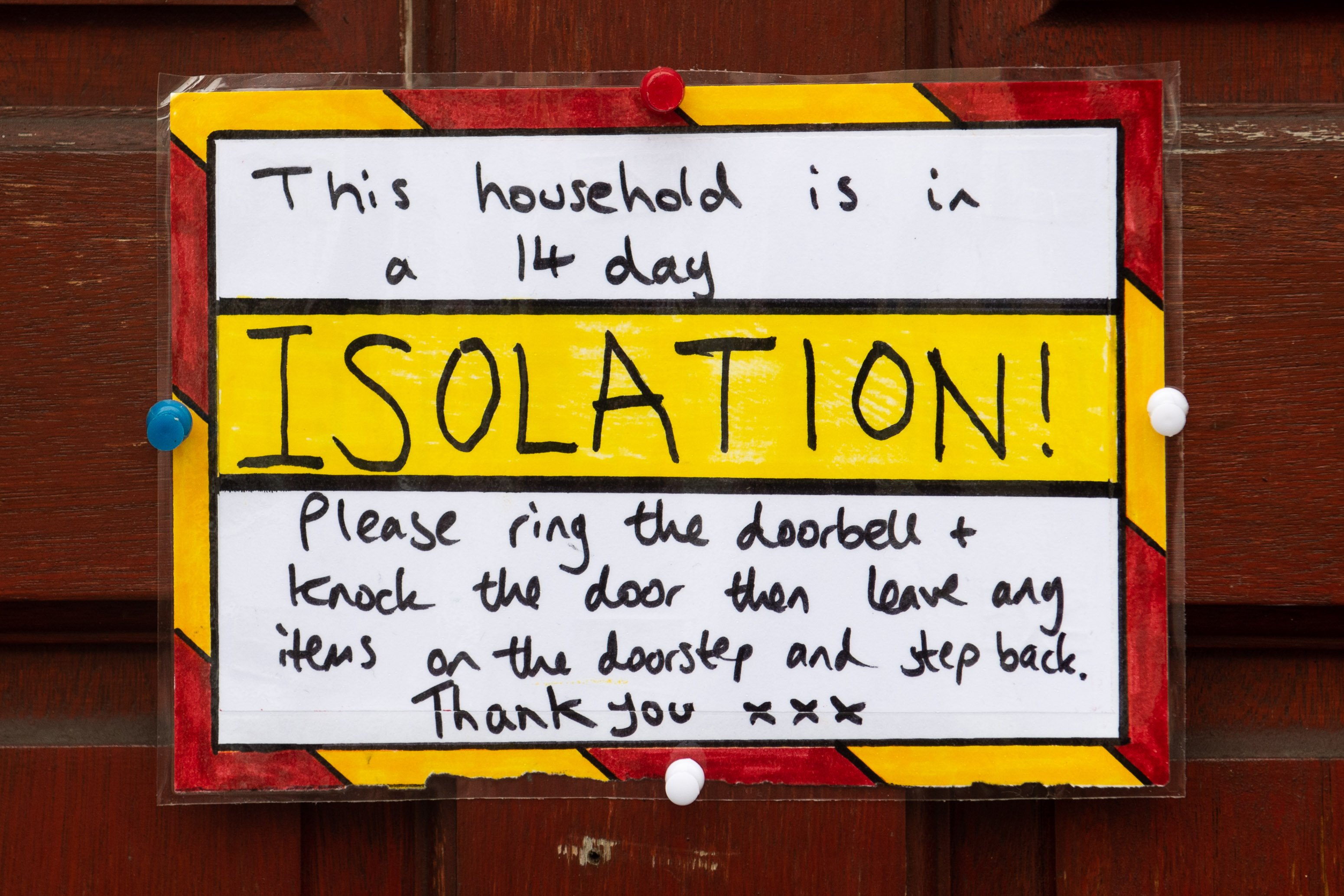  A sign on the door of a residential property where the household are in a 14 day isolation in accordance with new government guidelines on March 18, 2020 in Cardiff, United Kingdom. | Source: Getty Images