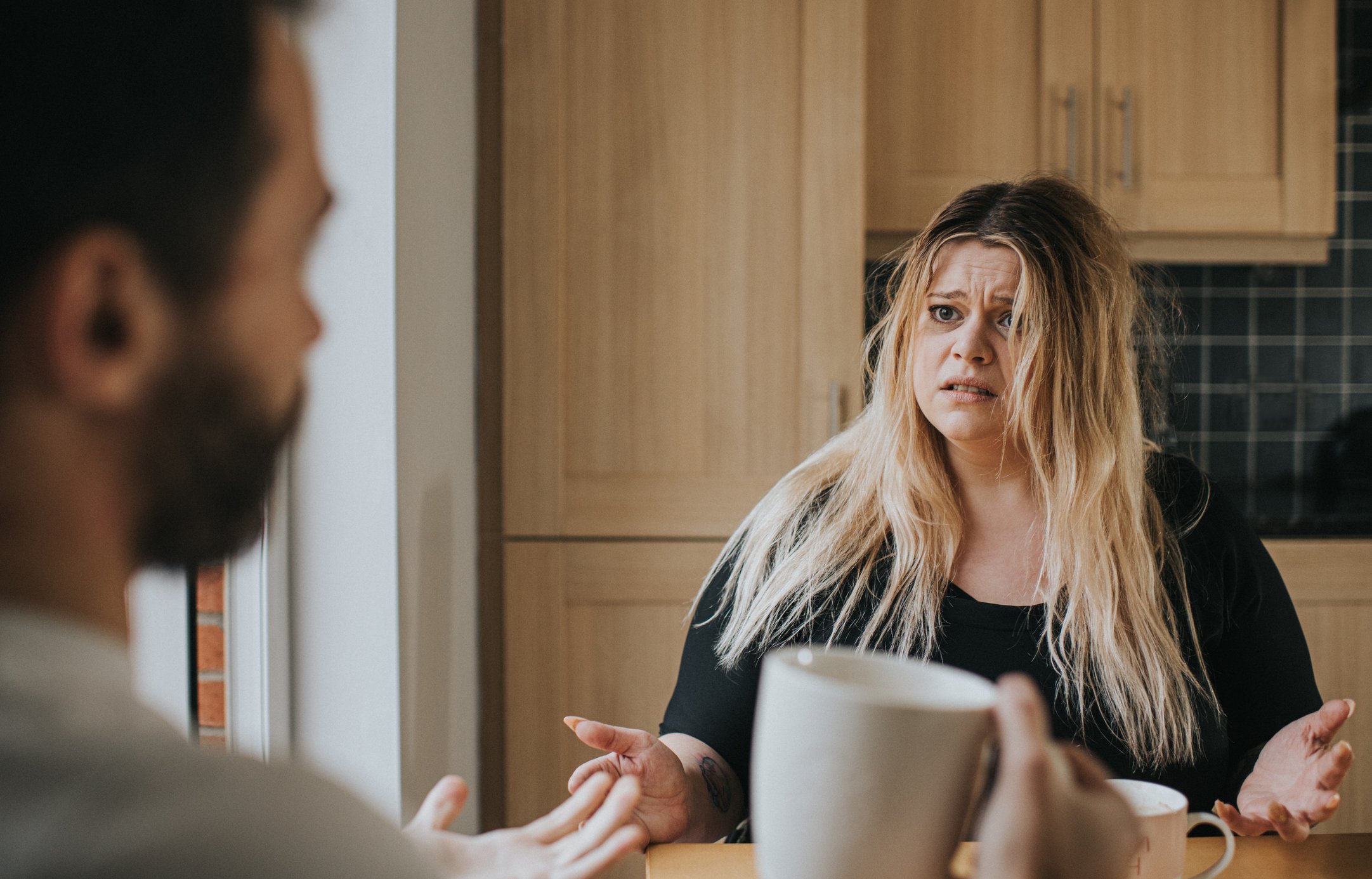 Couple argue at a kitchen table | Photo: Getty Images